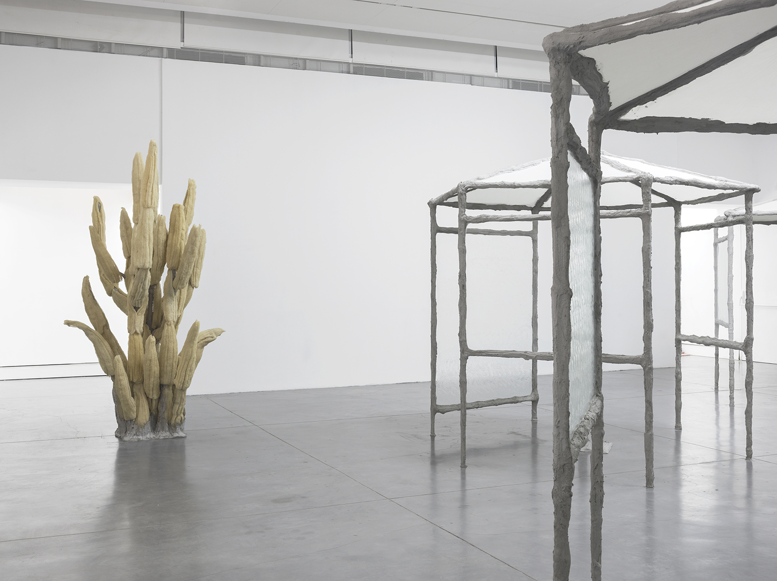 Springs, 2017, concrete, steel, burlap, glass, vaseline, egyptian loofah, hand towels, plaster, pigment, umbrellas