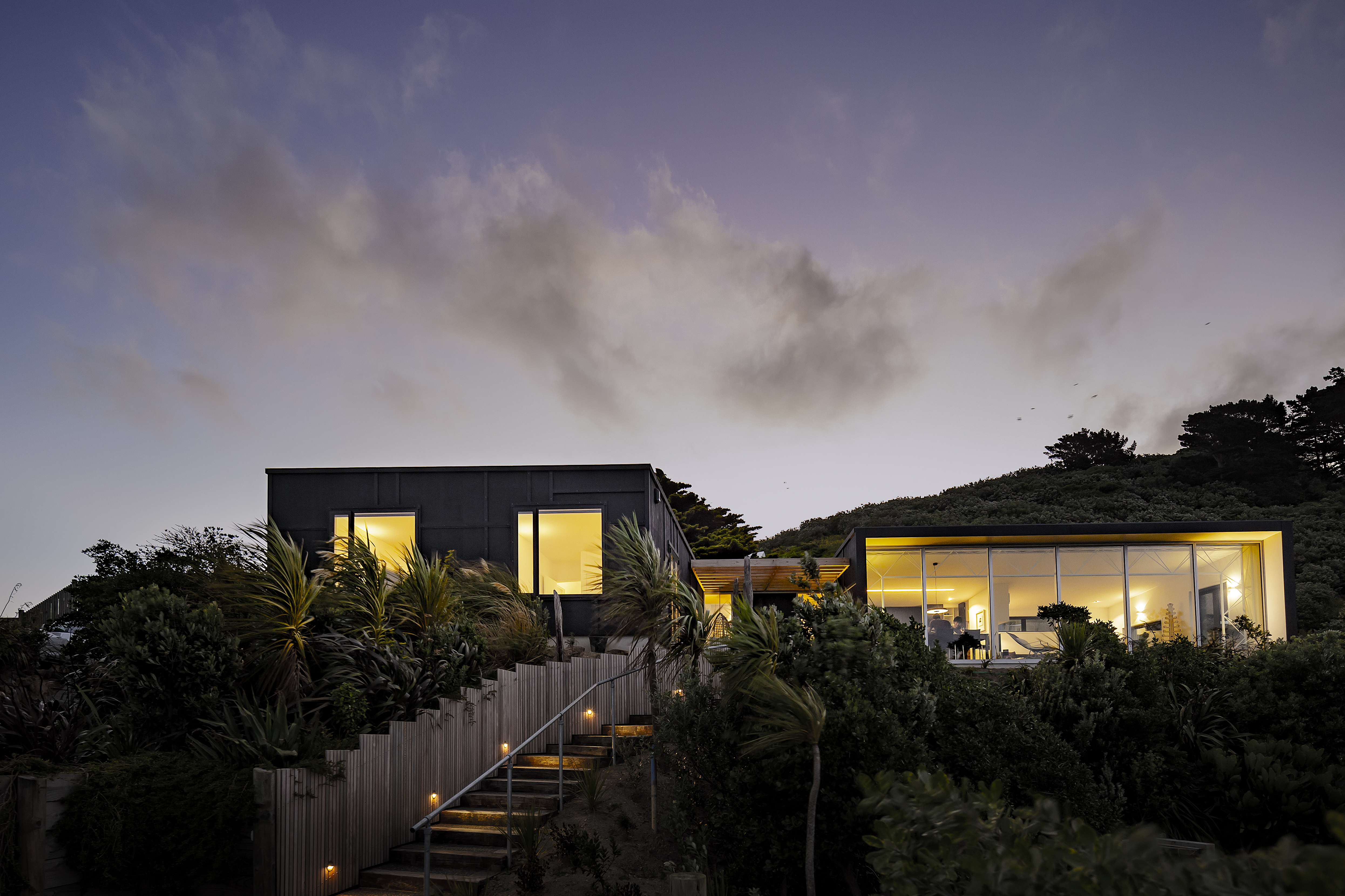 This home has gained the nickname Lyall Bay TV due to the views framed by the main living room window. A superbly crafted bespoke steel truss spans the length of this space.