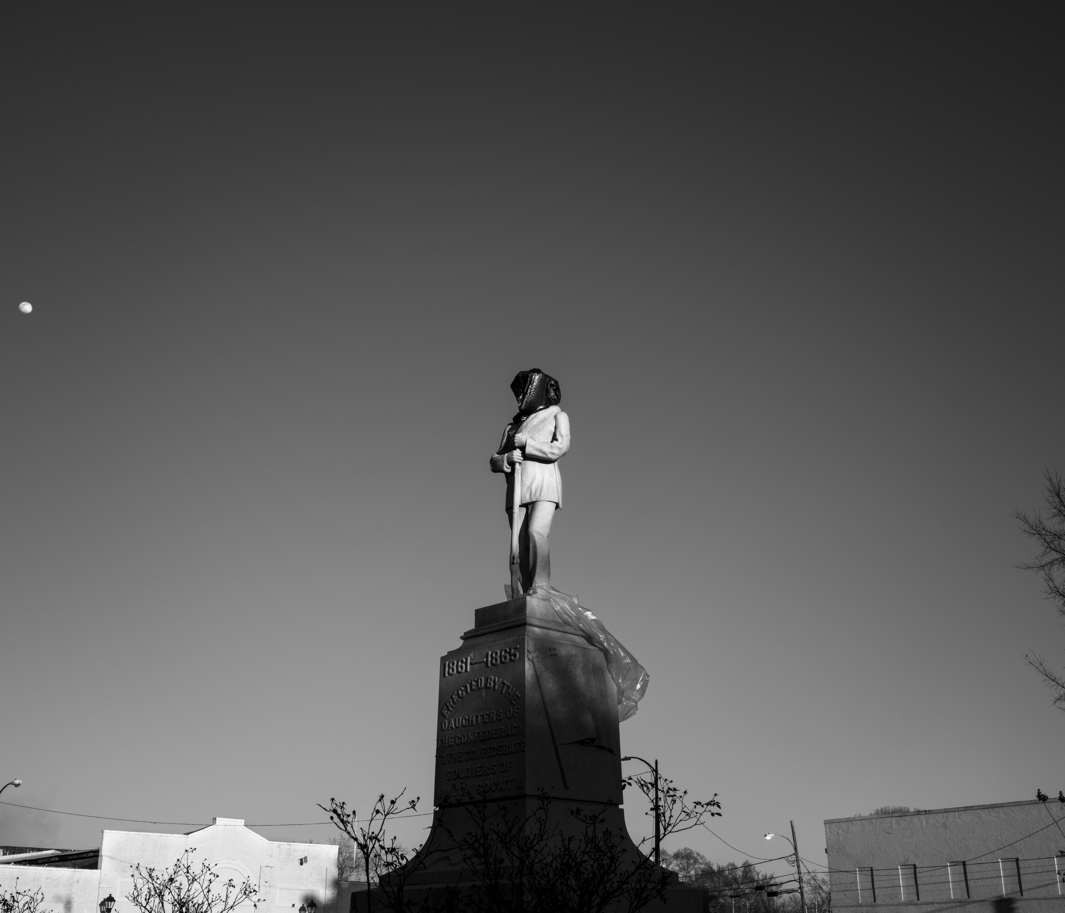 Tuskegee, Macon County — Confederate monument. In recent years Macon County citizens, led by former Tuskegee mayor and city councilman Johnny Ford, have made several attempts to remove or cover the Confederate monument in the town square. Erected by the Daughters of the Confederacy in 1906 on a plot gifted by a then White-controlled county government, the statue became the centerpiece of the Whites-only park–a racist, White supremacist symbol placed in the heart of one of the most historically and culturally significant African American communities in the nation. In July 2021 Ford attempted to topple the monument with a concrete saw, cutting through a leg before being stopped by the local sheriff. “We cannot, in Tuskegee, Alabama, the birthplace of Rosa Parks, the home of the Tuskegee Airmen, the home of Tuskegee University, this historic city, have a Confederate statue in a park built for White people,” Ford said in a report by the AP. Yet recent legal efforts by city officials to remove the statue have stalled, particularly in light of state legislation written to protect Confederate monuments. In February 2022 the Alabama state legislature advanced a bill that would increase the fine for violating the Alabama Memorial Preservation Act of 2017 from a $25,000 one-time fine to $5,000 per day.