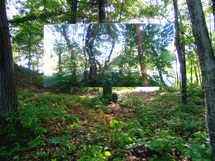 Gunshot Lanscape (summer view), 2003, mirror-polished double-sided stainless steel panel suspended by aircraft cable, 46x94 in, Collection of The Fields Sculpture Park, Ghent, NY