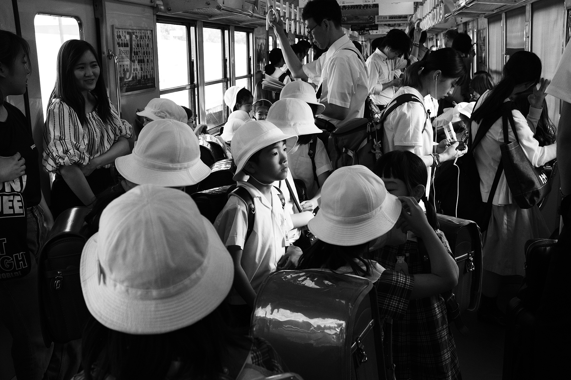 Philippe-Sarfati-early-work-photography-photographer-street-documentary-black-and-white-tokyo-japan-subway-children-school-uniform-hats-child-lost-in-thought