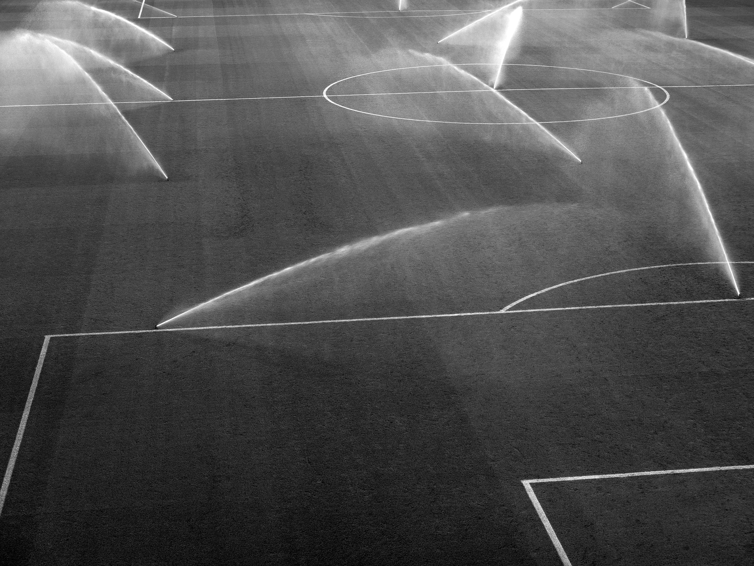 Watering the football field Pamplona, Spain, 2023photography, bw, single