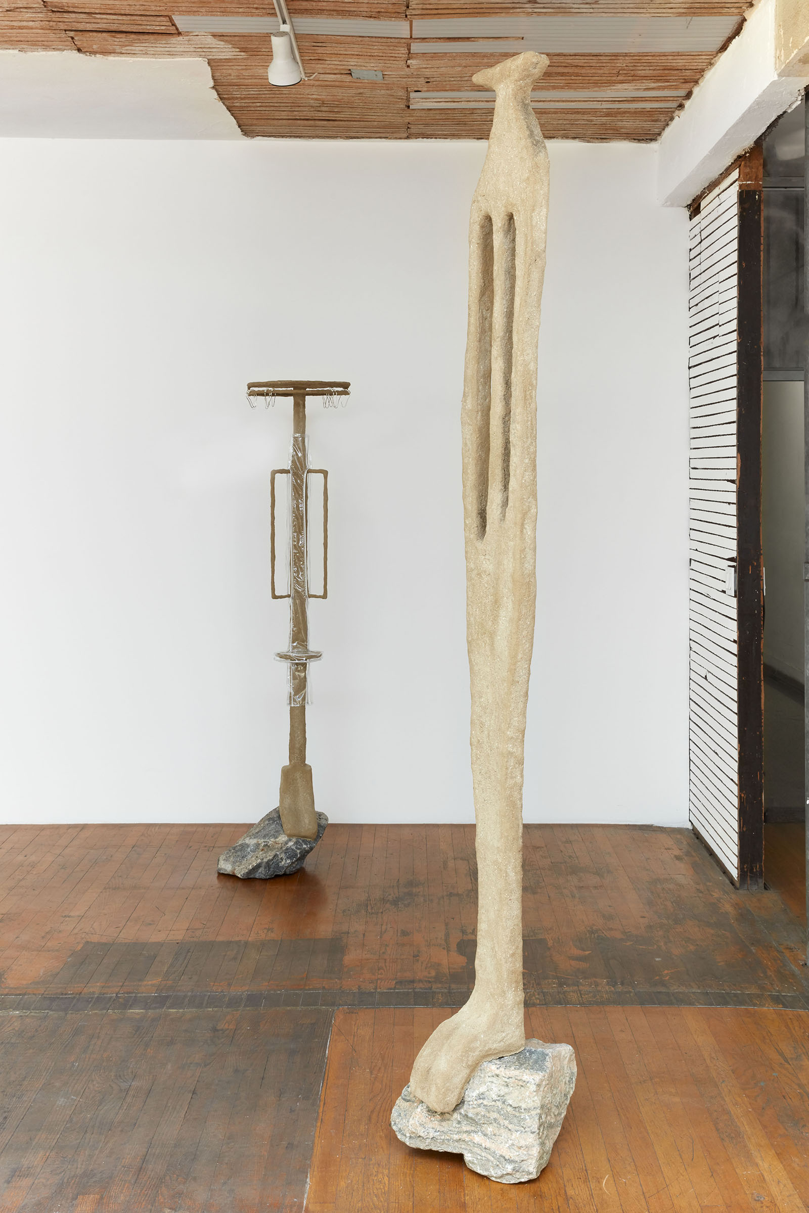 Thirst Trap (installation view), 2021, steel, sand, polymer, burlap, rock, vinyl, shower curtain hooks, toothbrushes