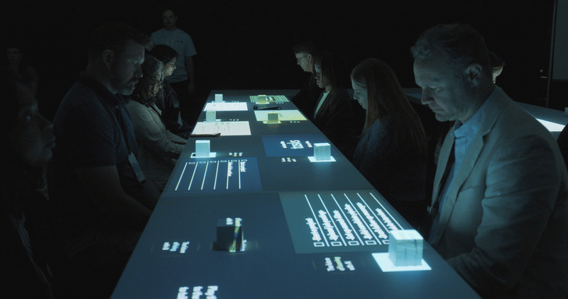 Each cube featured reflective tape on the top, which was sensed by Infrared cameras installed above our guests. As they slid the cube across their desktop, they could create light trails and reveal key insights that helped to communicate the power of LinkedIn’s AI.