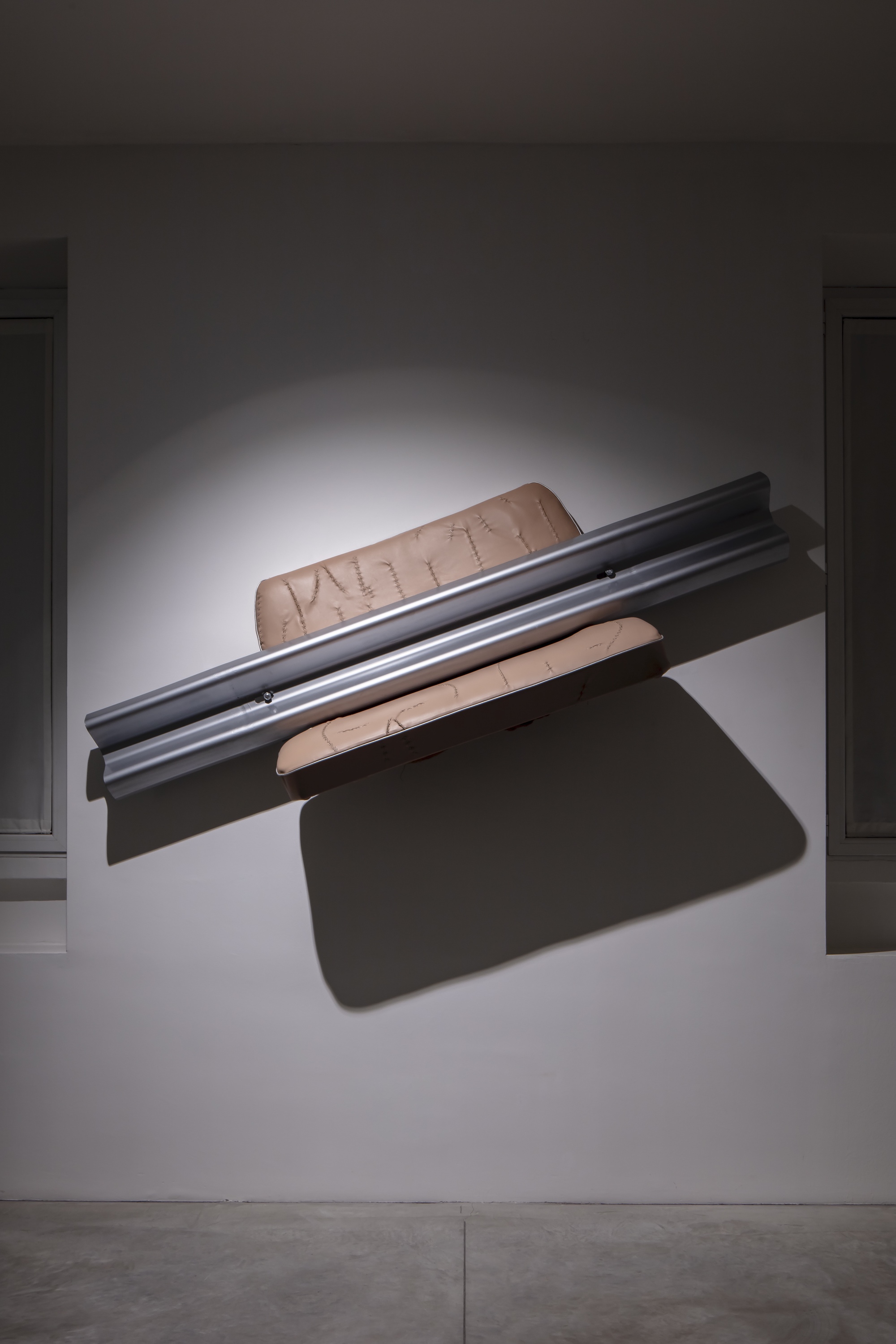 SITTING CRASH, 2022sedili di auto rivestiti in pelle con cuciture capitonné car seats covered in leather with capitoneé stitchingmetallo (guardrail) worked metal (guardrail)installazione a muro, (239 x 81 x 41 cm) wall installation, (239 x 81 x 41cm) ed. unica unique work