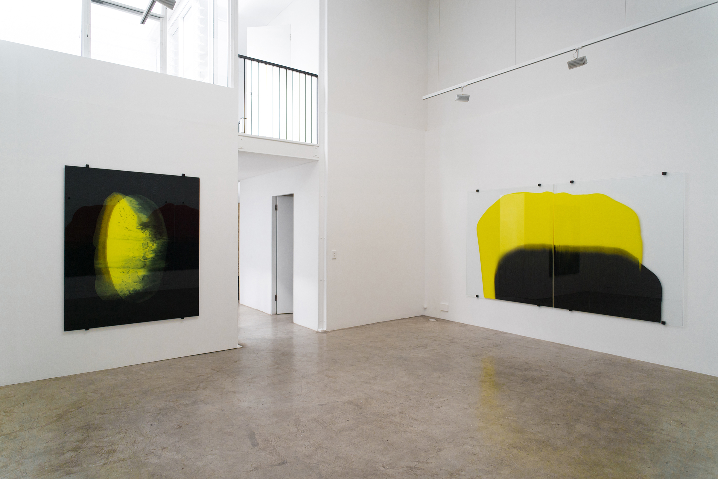 L-R Yellow moon, 2017, acrylic paint on glass 160 x 140cm and The Free Act (yellow and black over two),  2017, acrylic paint on glass 160 x 280cm 