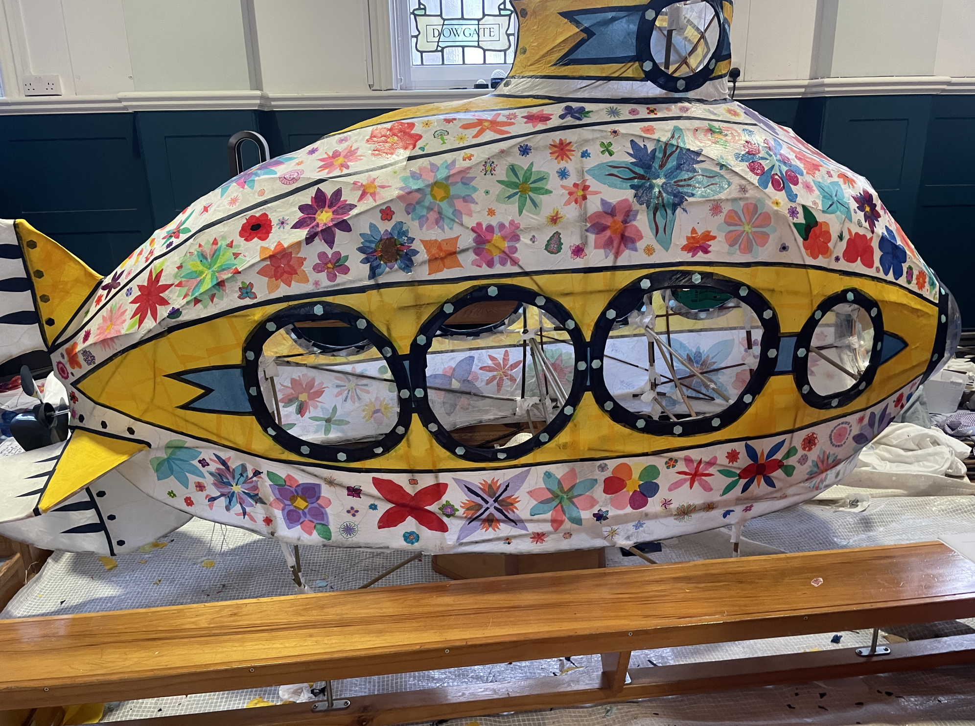 In 2024, I collaborated with Key Stage 2 students at Aldgate Primary School on the theme of 'magical modes of transport.' Together, we crafted woven wicker frames and vibrant tissue paper sculptures, exploring connections between sculpture and performance art along the way.