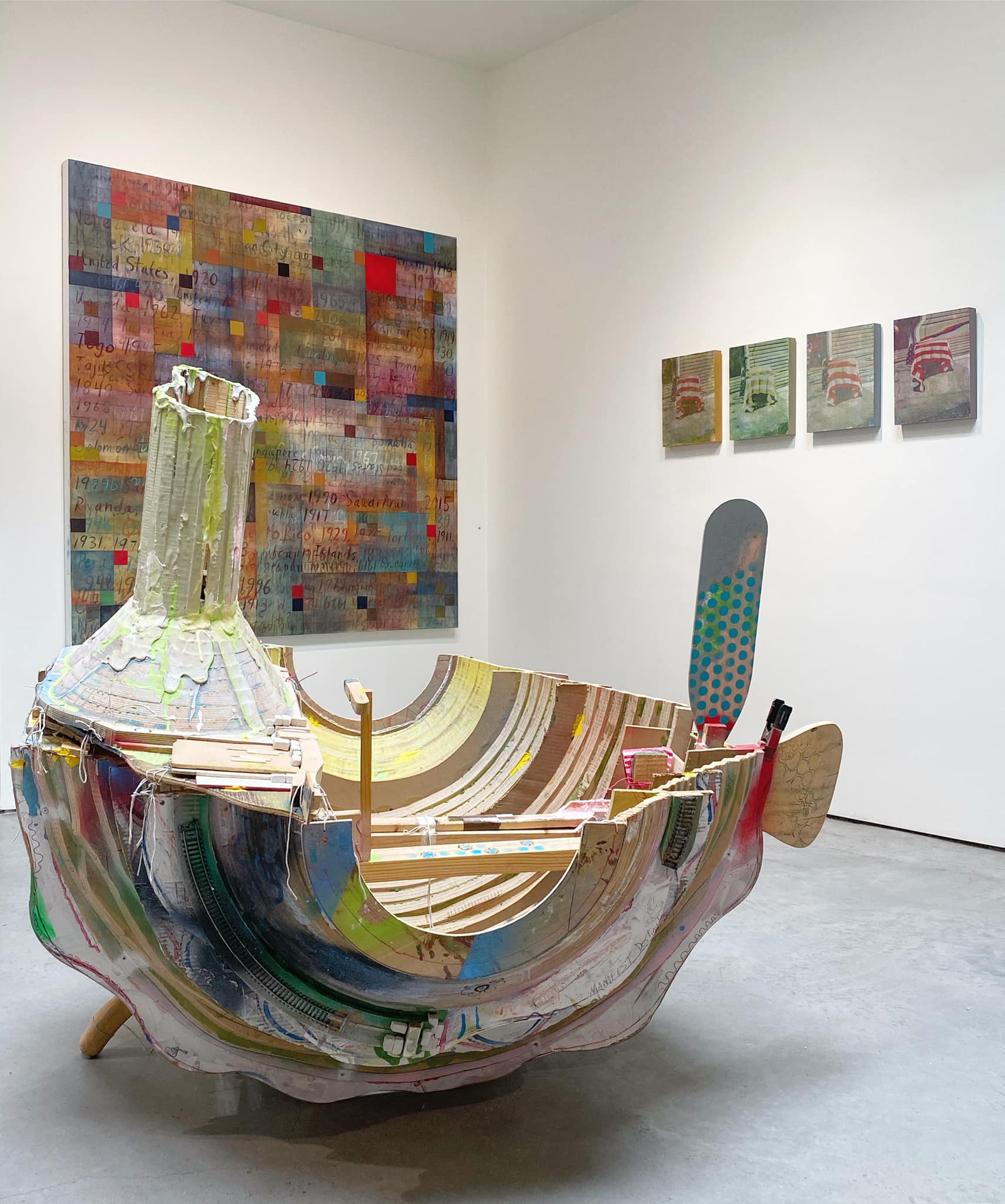 Artwork Titled, Vessel of Manifest Destiny! (2nd Permutation) (2019) by Travis Townsend. A section of an abstract wooden boat, decorated with splotches of various colors of paint with, possibly, a short smokestack at one end.