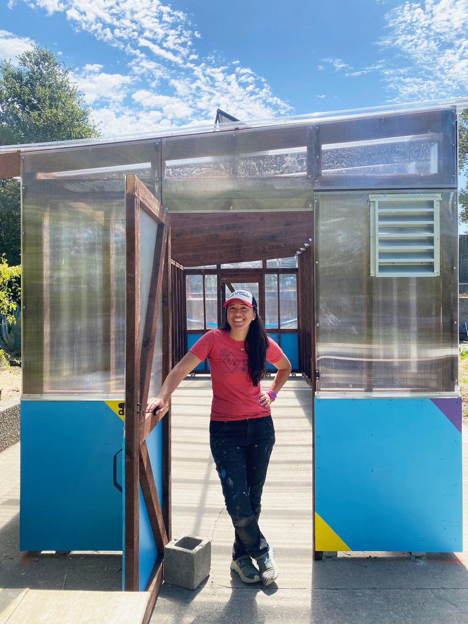 Emily in the entrance of a greenhouse built by Girls Garage students for a local middle school.