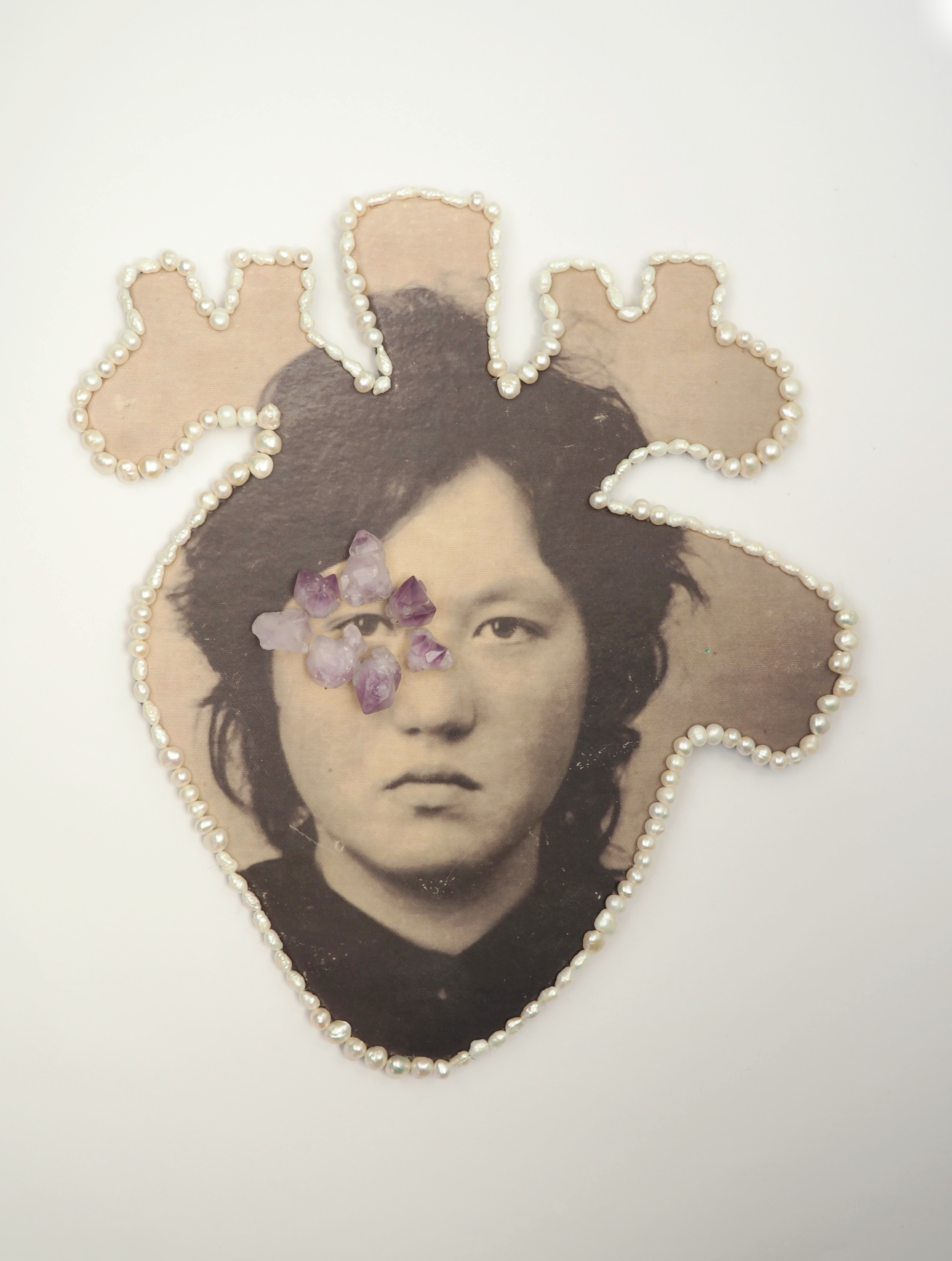 Crystallised Heart Portrait, 2025 Archival family photo hand printed on textile, freshwater pearls, raw amethyst stones, stainless steel wire,pressed cupboard, wool. 28 x 22 cm