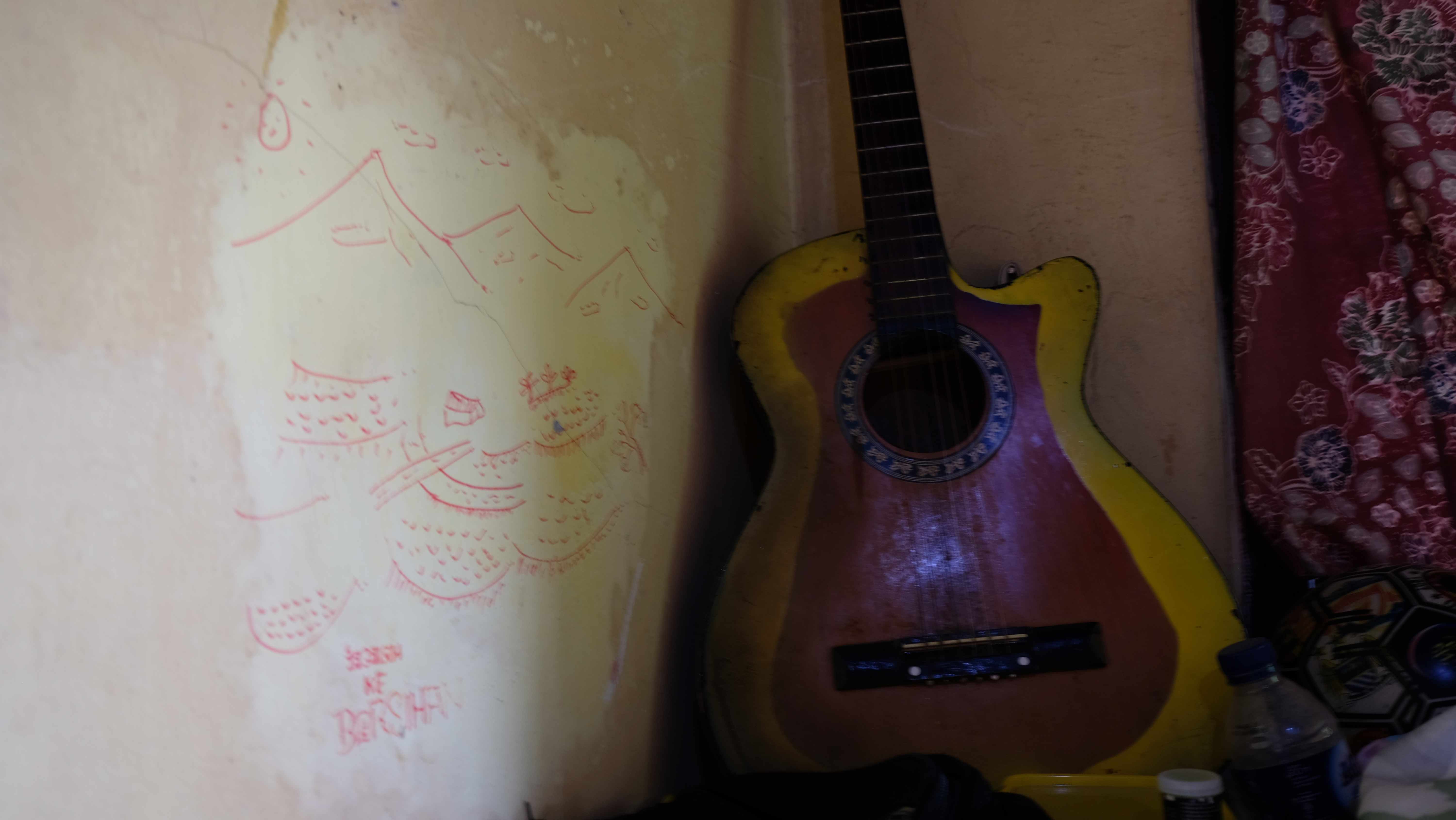 A drawing of mountains, hometown of the resident that is now in a tiny room, at the sea