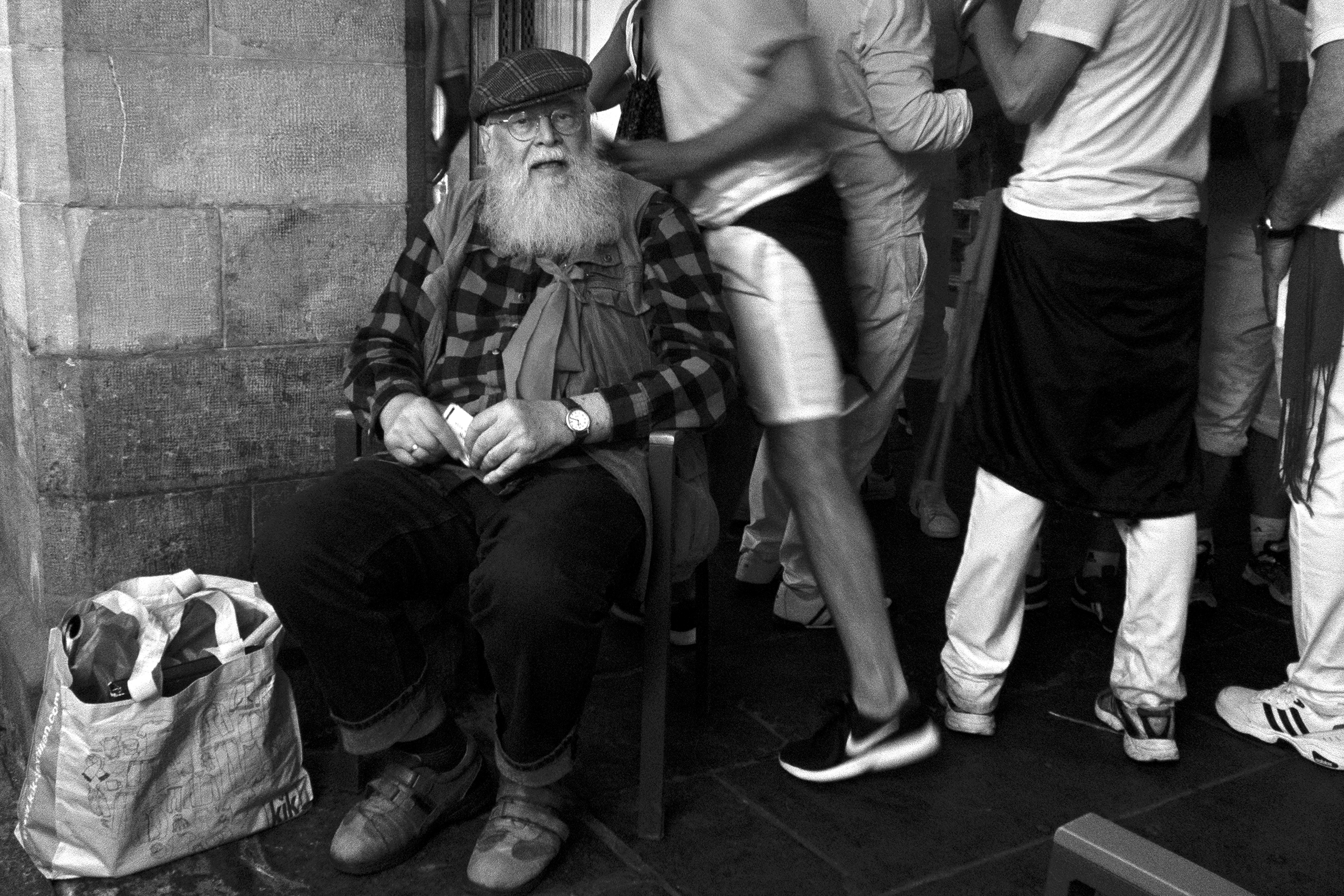 Hemingway lookalike seated in the middle of the fiestaPamplona, Spain, 2022photography, bw, single