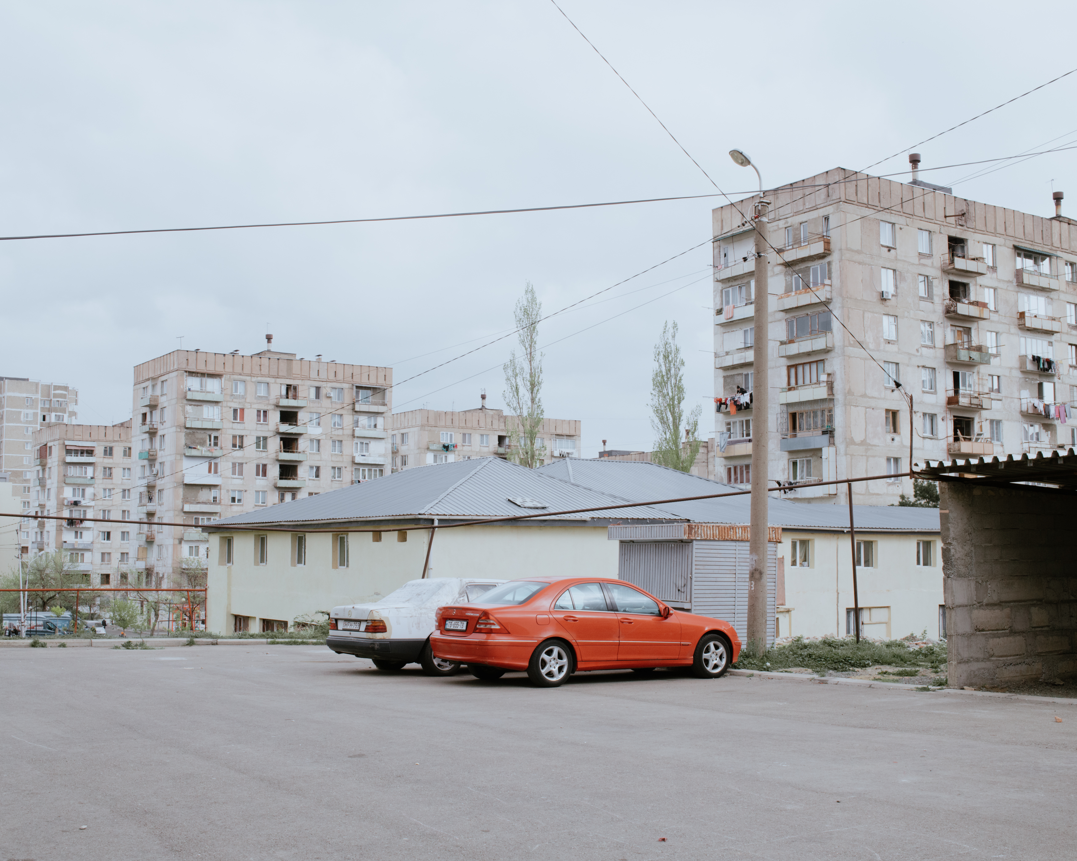 Cars parked in front of a residential building in the Gldani district in Tbilisi