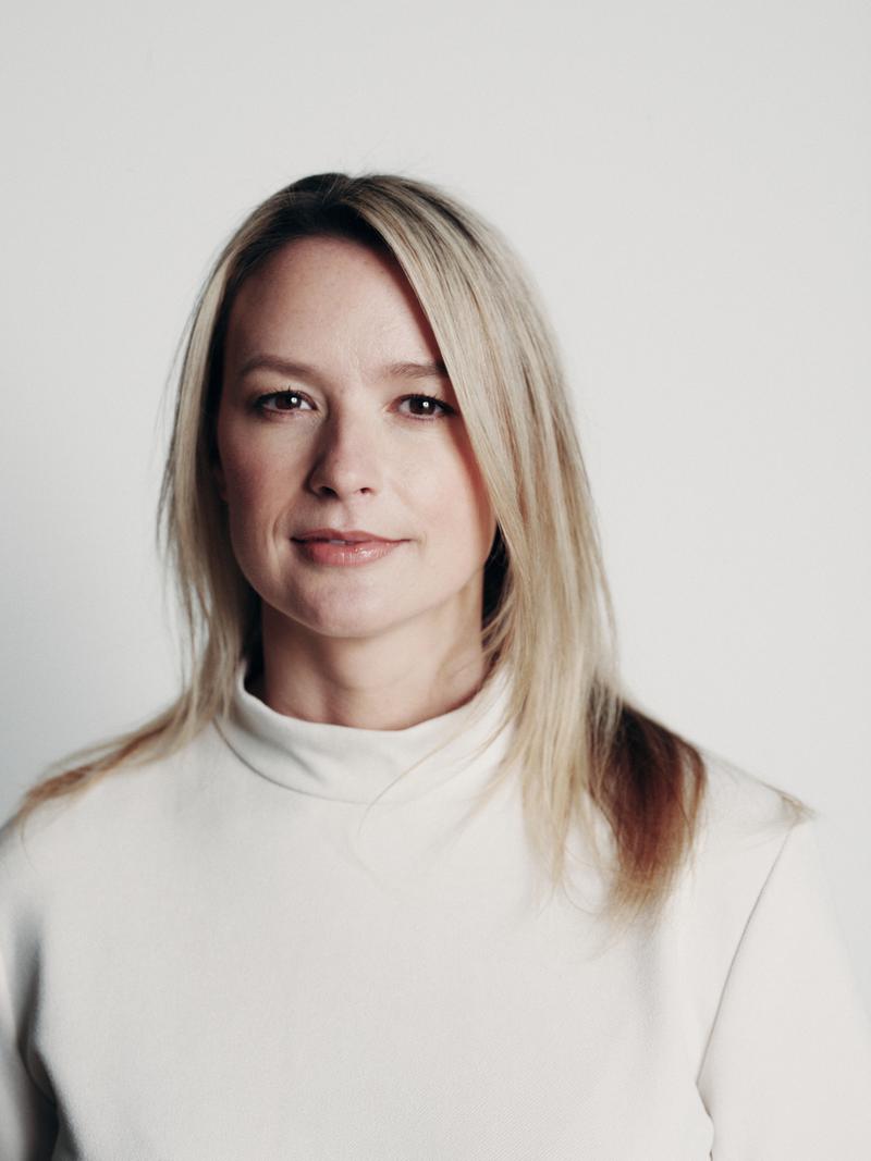 Victoria Buckley, Finance Director at UP! Productions, photographed in a cream jumper against a white background.”