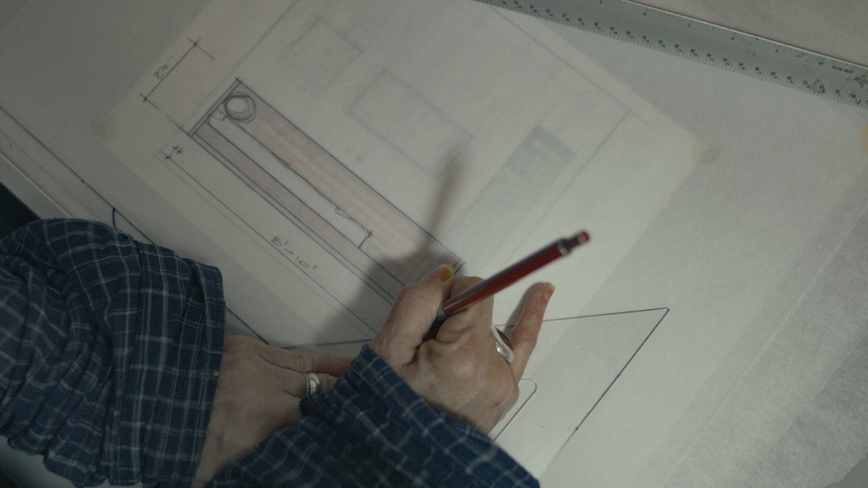 Leslie sketches the outlines of a console table.