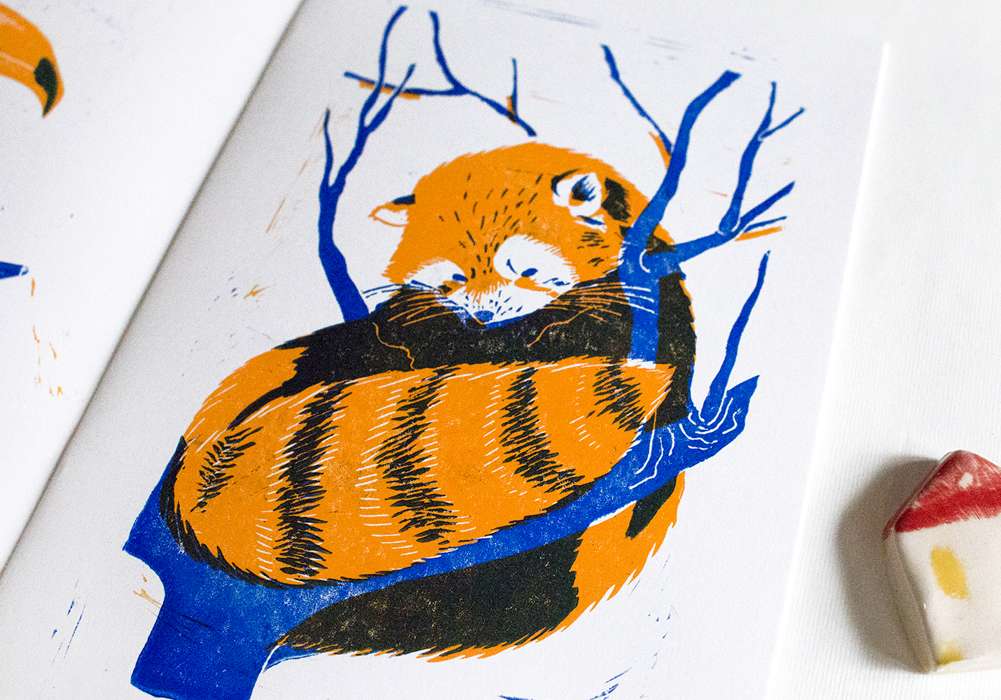 a red panda sitting on a tree