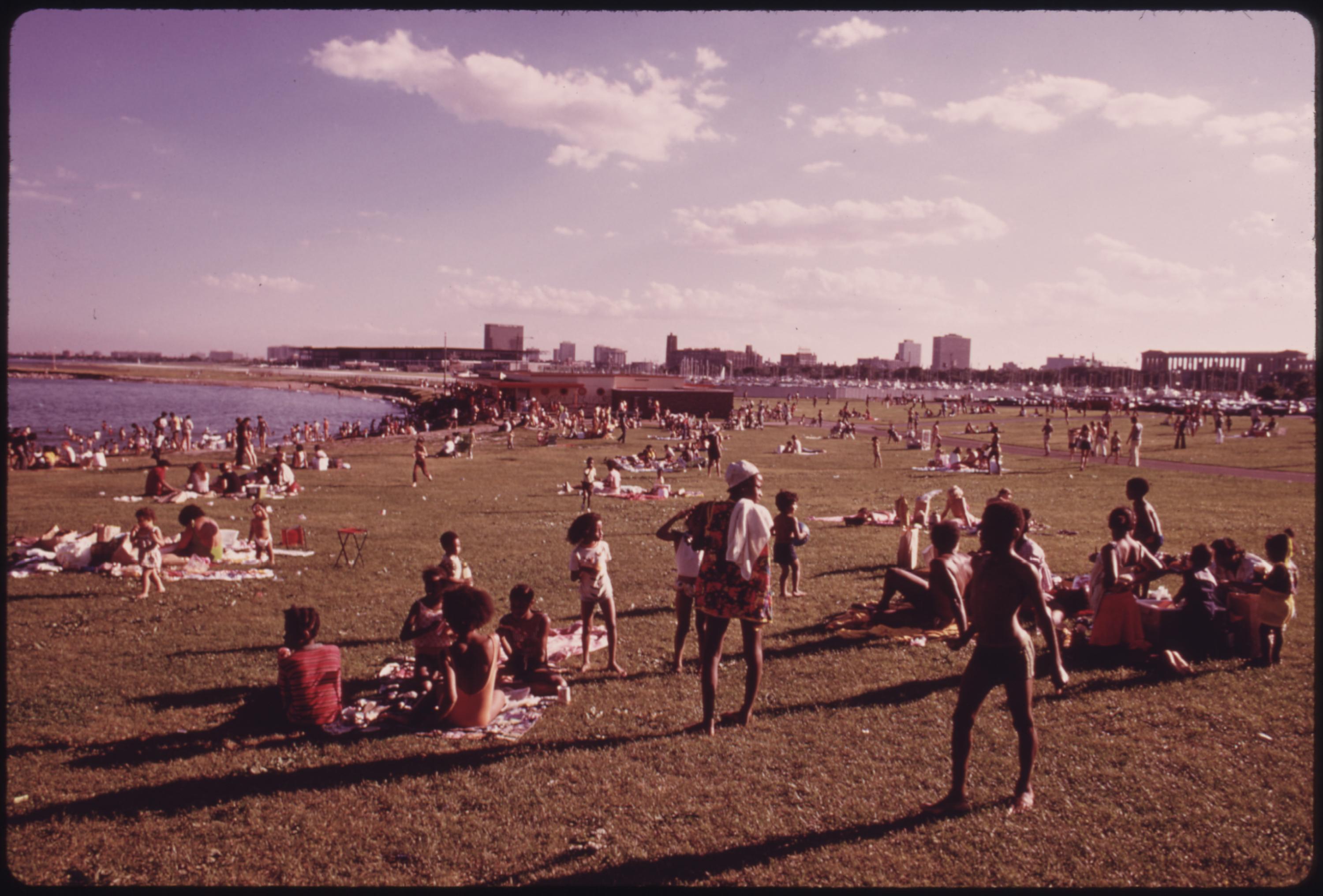 Chicago families enjoying the summer weather at the 12th Street Beach on Lake Michigan. From 1960 to 1970 the percentage of Chicago Blacks with an income of $7,000 or more jumped from 26 to 58 percent. Median Black income during the period increased from $4,700 to $7,883, but the dollar gap between their group and that of whites actually widened, August 1973.