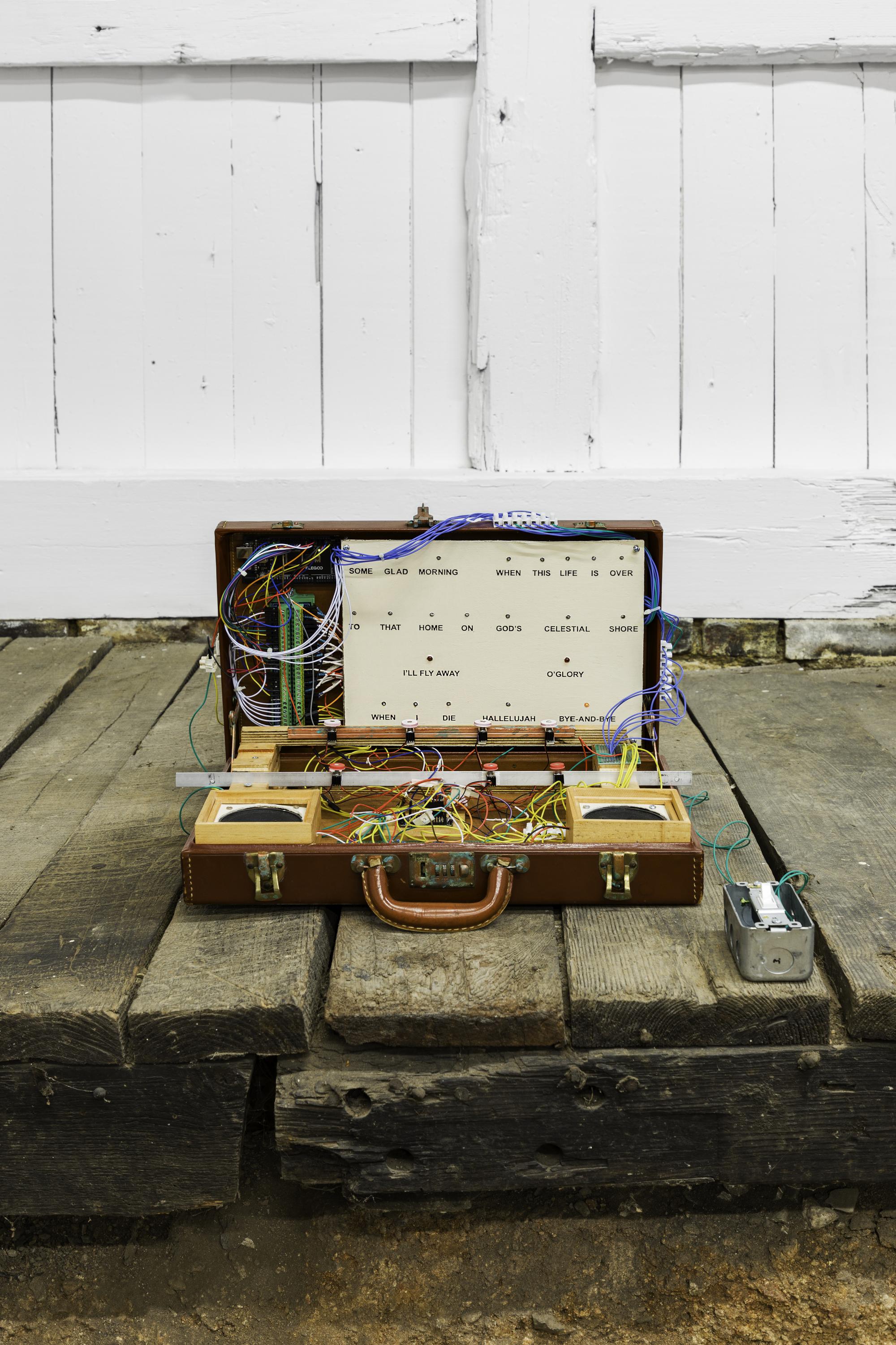 That Land Where Joy Will Never End (Folk Song Machine IV) briefcase, wood, aluminum, LEDs, transistor array, solenoids, sound modules, 8ohm speaker, amplifier circuit, hookup wire, Arduino Mega, foam earplugs, single-pole switch