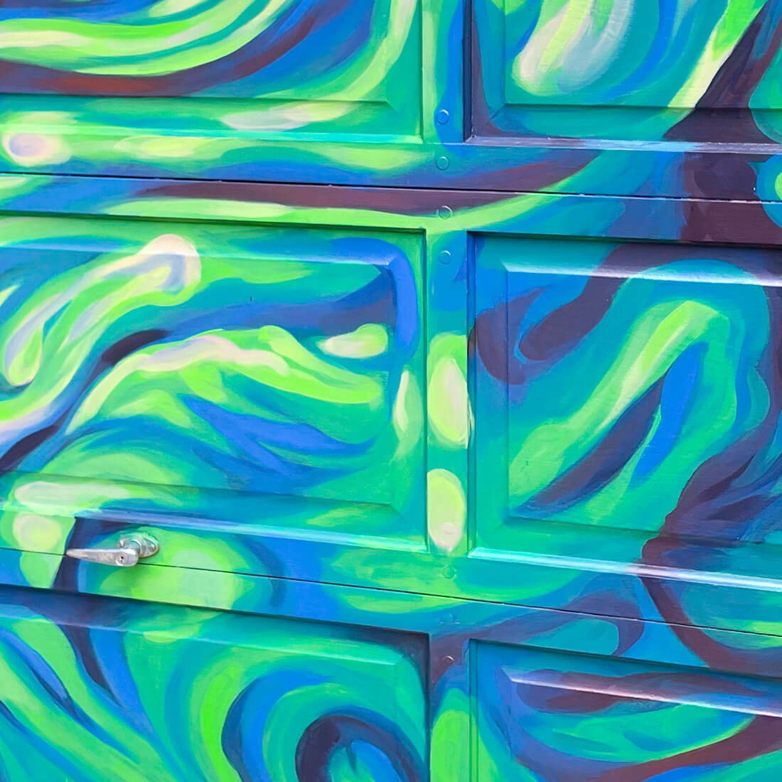 psychedelic mural on garage with blue toned mural free flowing shapes