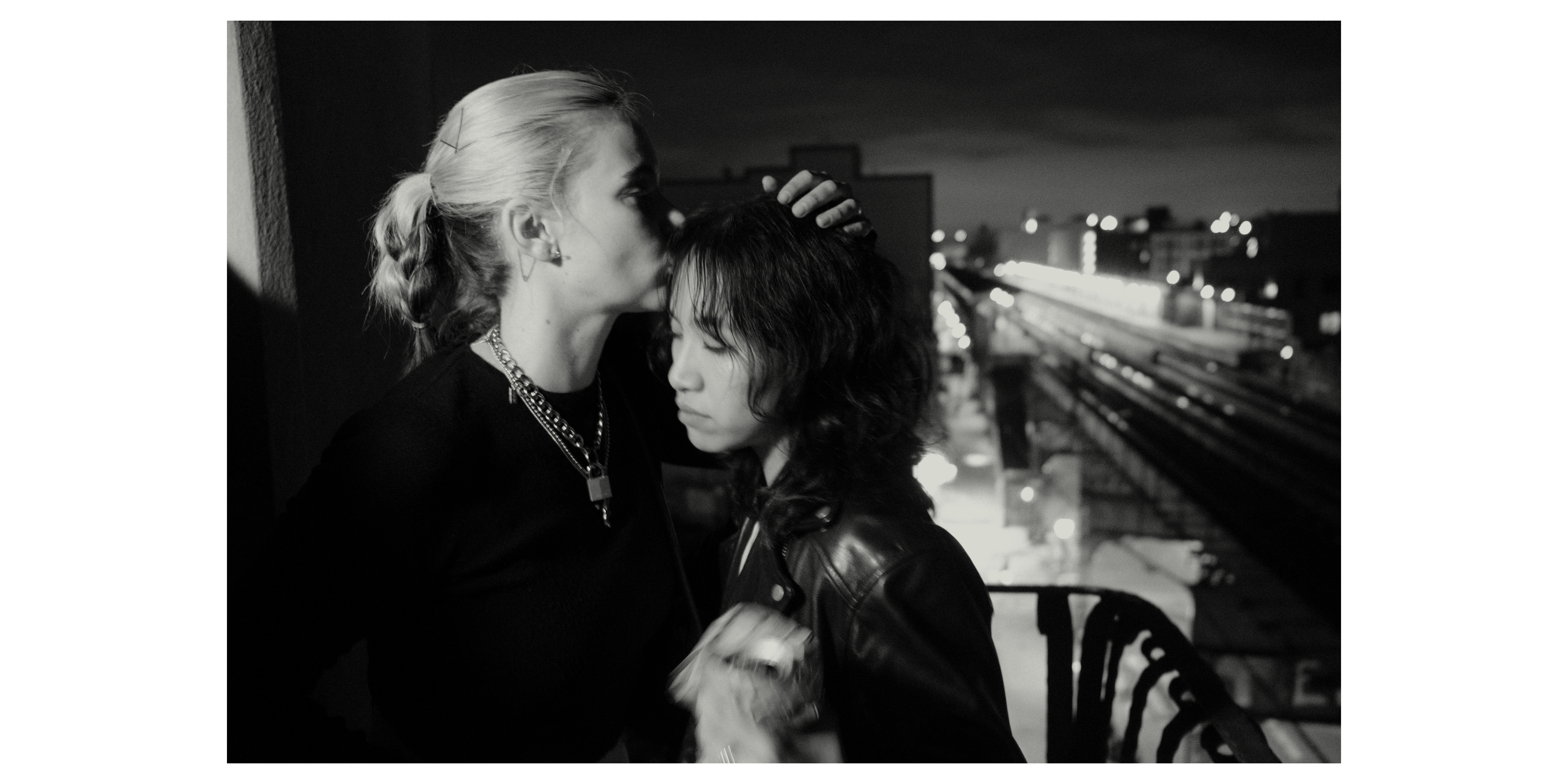 Kissing a friend on the balcony