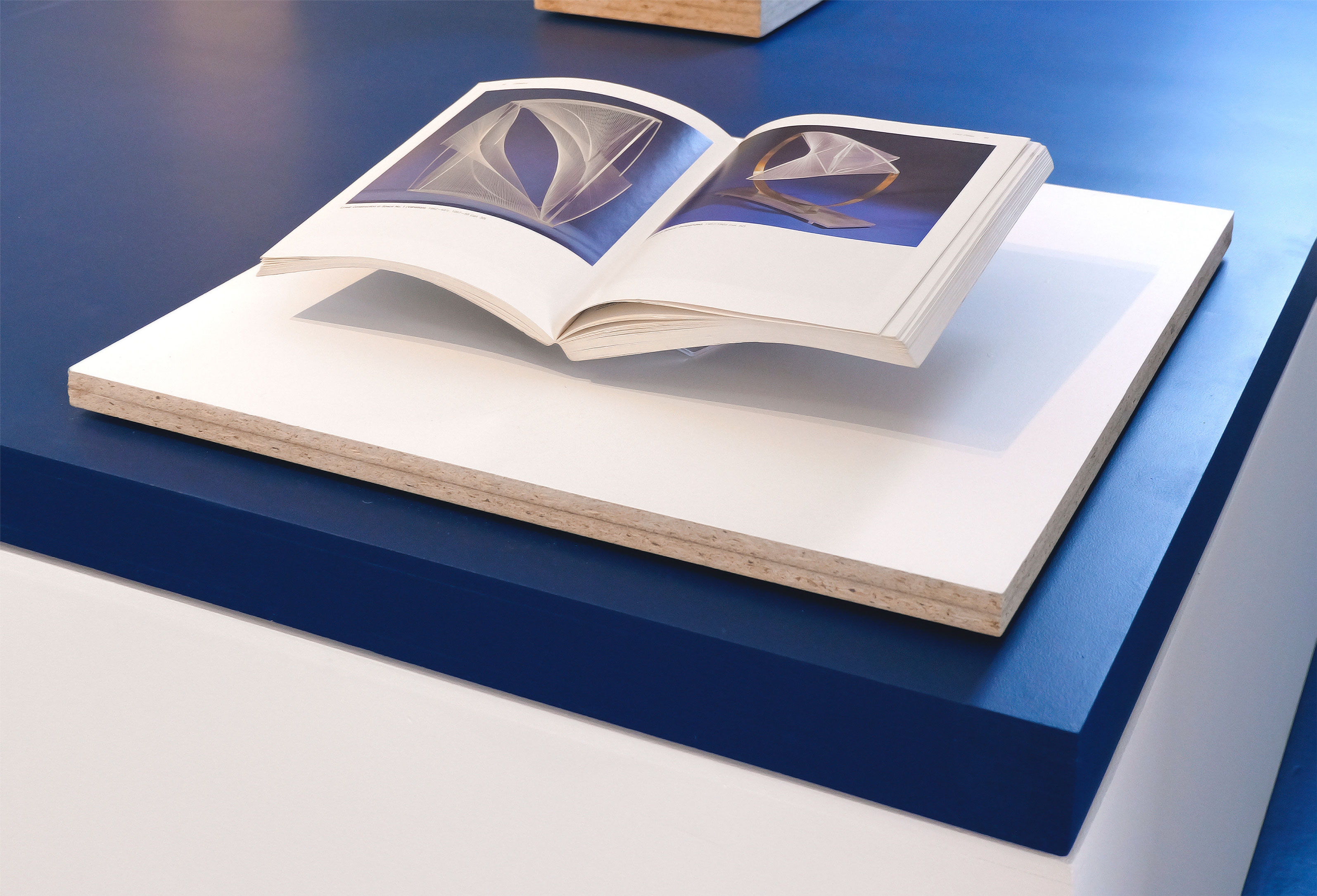 'The Crypt' (2025) &ndash; Detail: painted chipboard, book - &lsquo;Naum Gabo: Sixty Years of Constructivism&rsquo;.