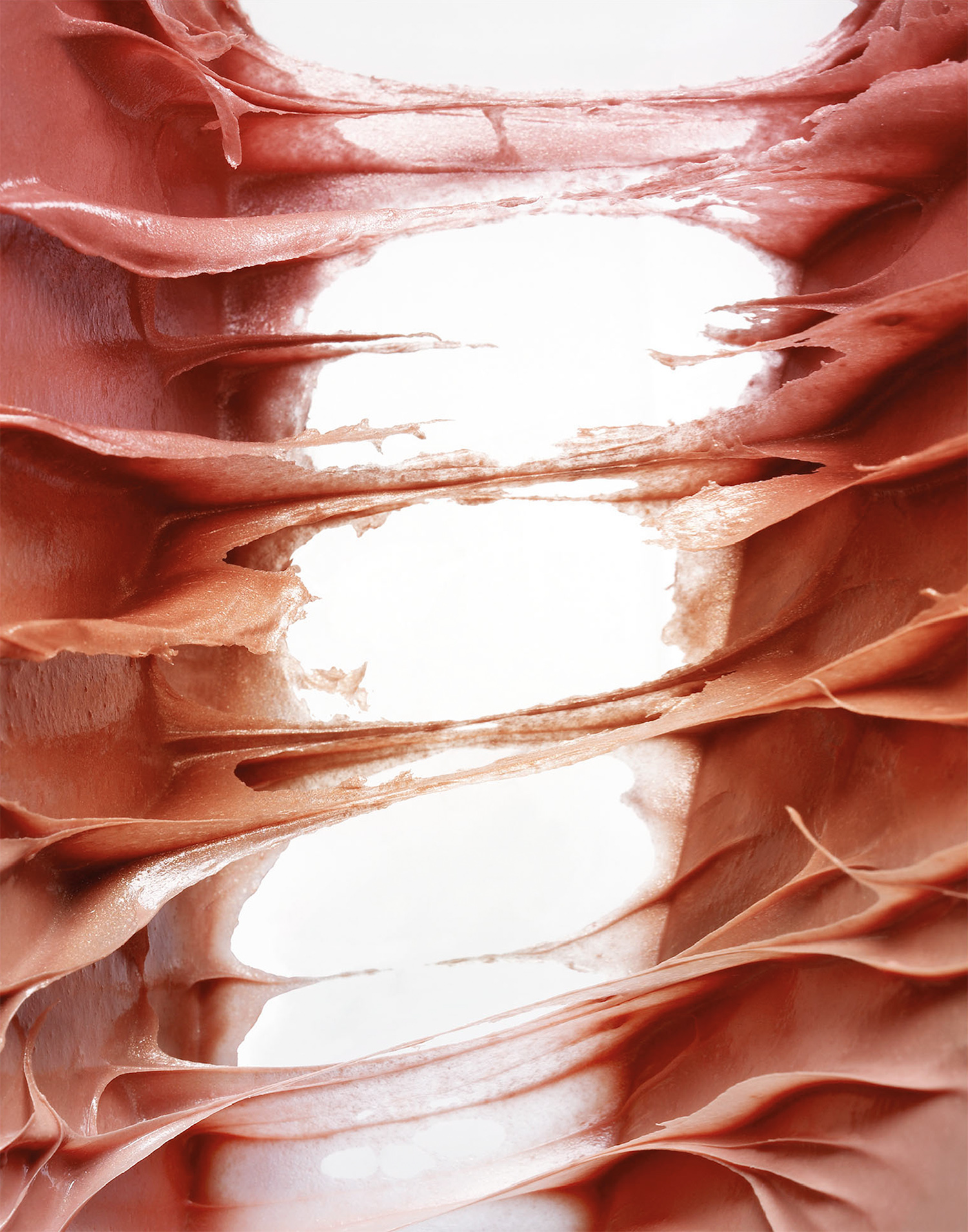 KMA photographer Daniel Schweizer shoots an abstract photo of pink sticky liquids pulling apart against a white background