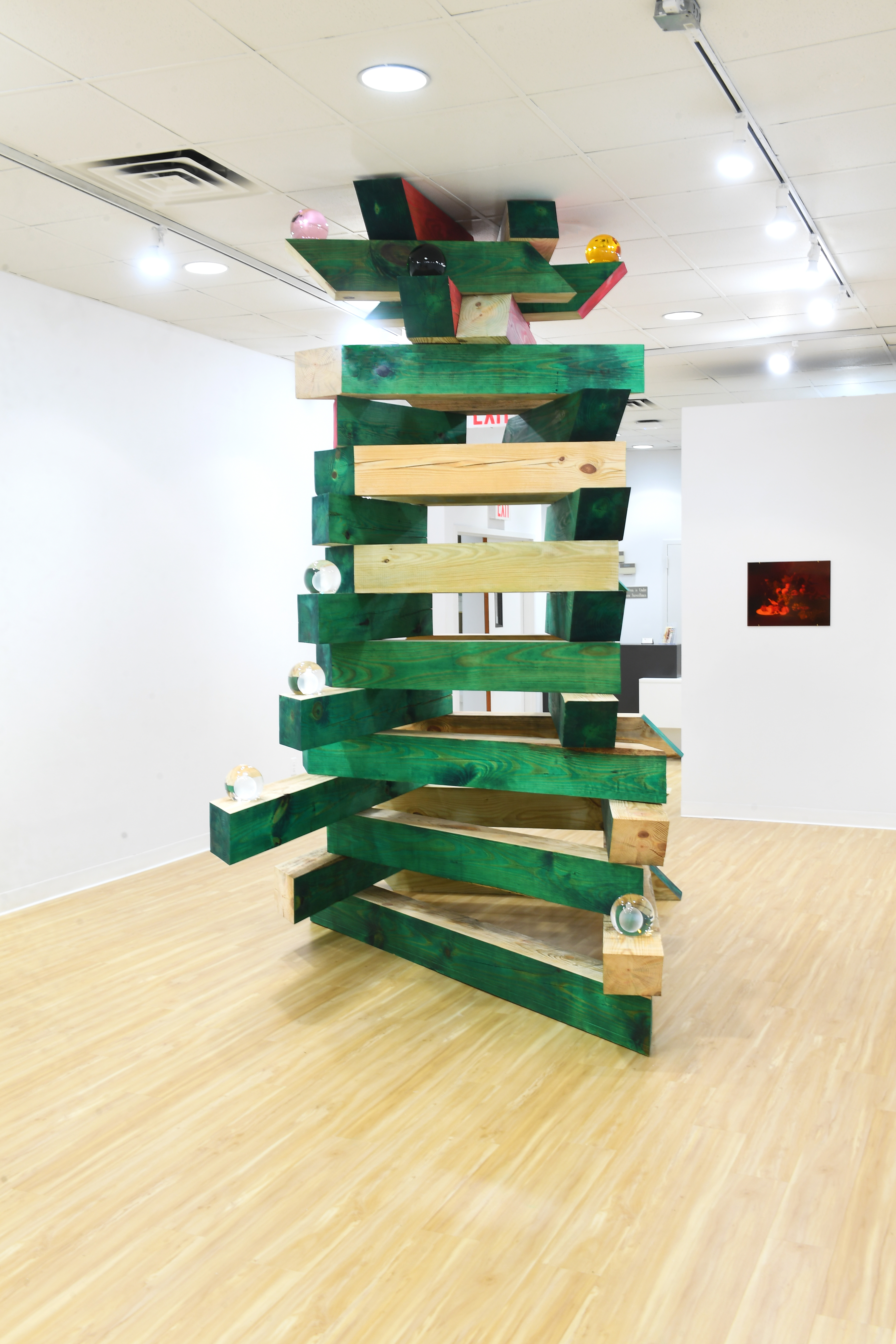 Christopher K. HoTriangle, 2019Pine, paint, Christmas ornaments, manipulated digital prints of Rosen paintings under red and green glass 10 x 10 x 6 feet (approximate)Courtesy the artistPhoto: Jad Nammour