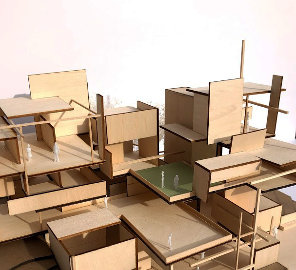 a laser cut basswood model of the new school - it is very geometric and almost looks like the building was frozen mid explosion