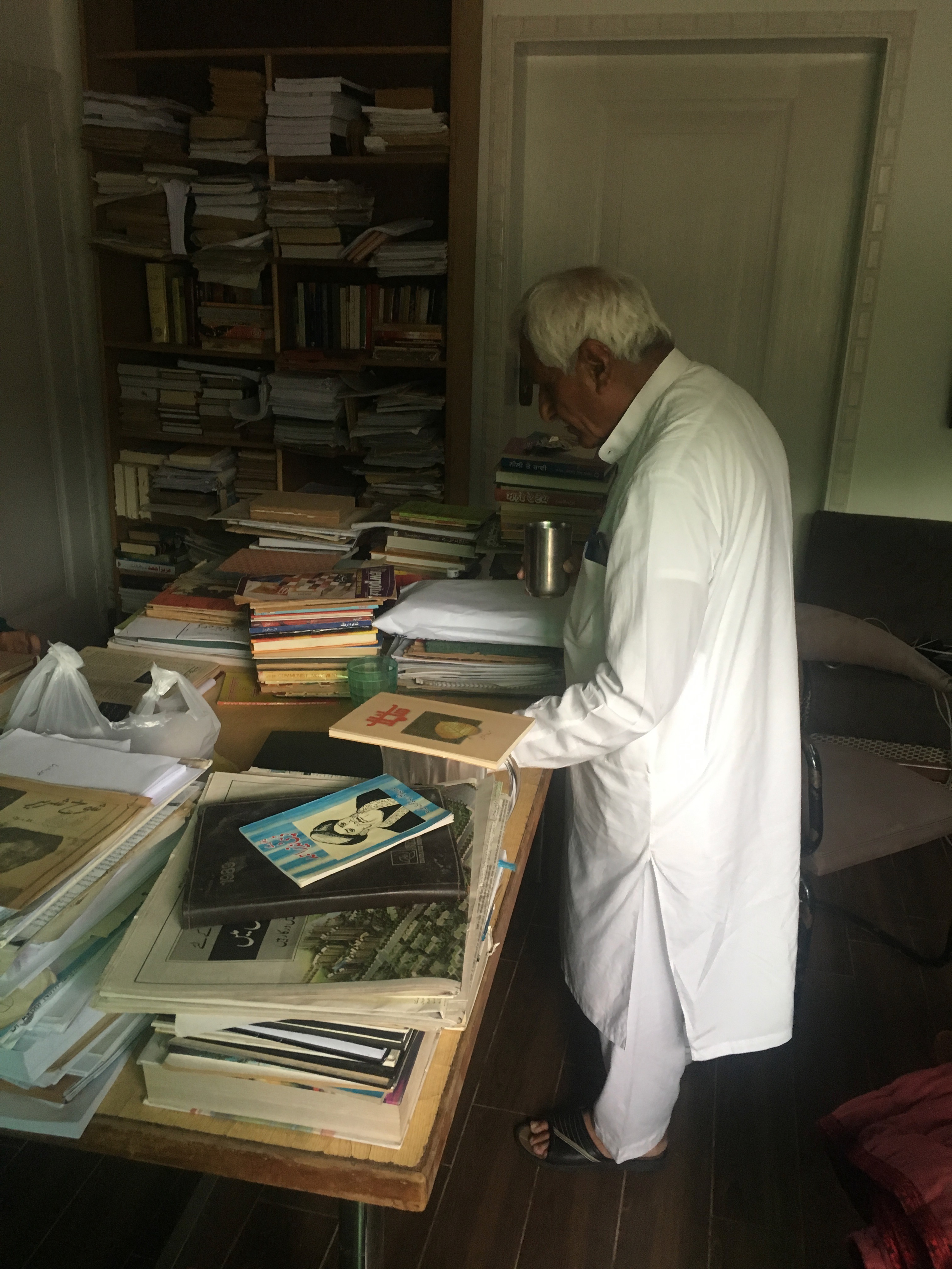 M.S. Khawaja searching magazines for visiting researchers