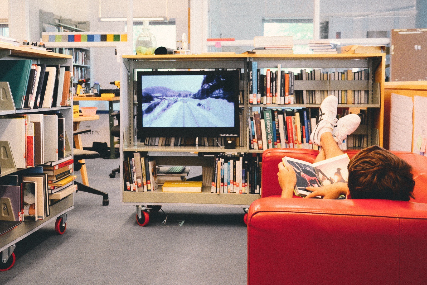 A visual radio is nestled into a moveable book stack.