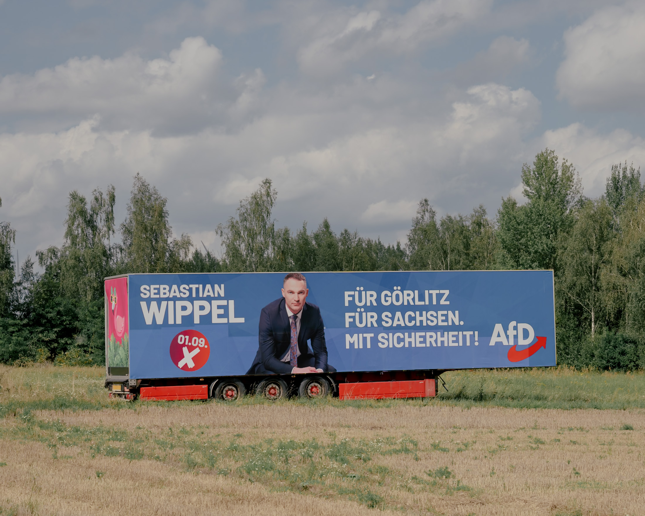 An AfD election poster of Sebastian Wippel for the state election on a truck tarpaulin next to the federal highway 115 near Görlitz, Germany on August 11, 2024. The election poster reads: "For Görlitz. For Saxony. With certainty!"