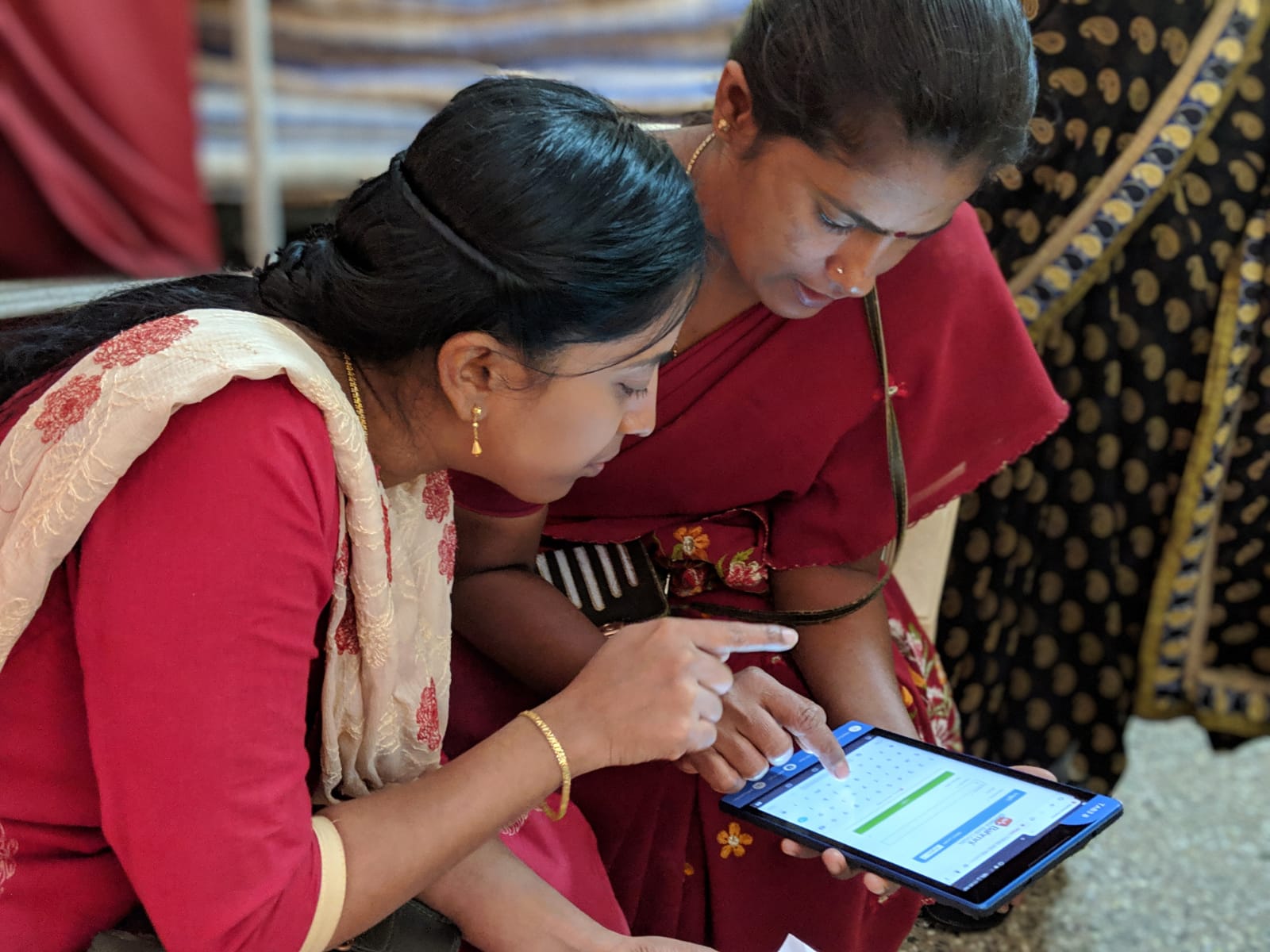 Medical practitioners using tablets and a digital healthcare system at the Mugulur Clinic. Source: St. John’s Research Institute.