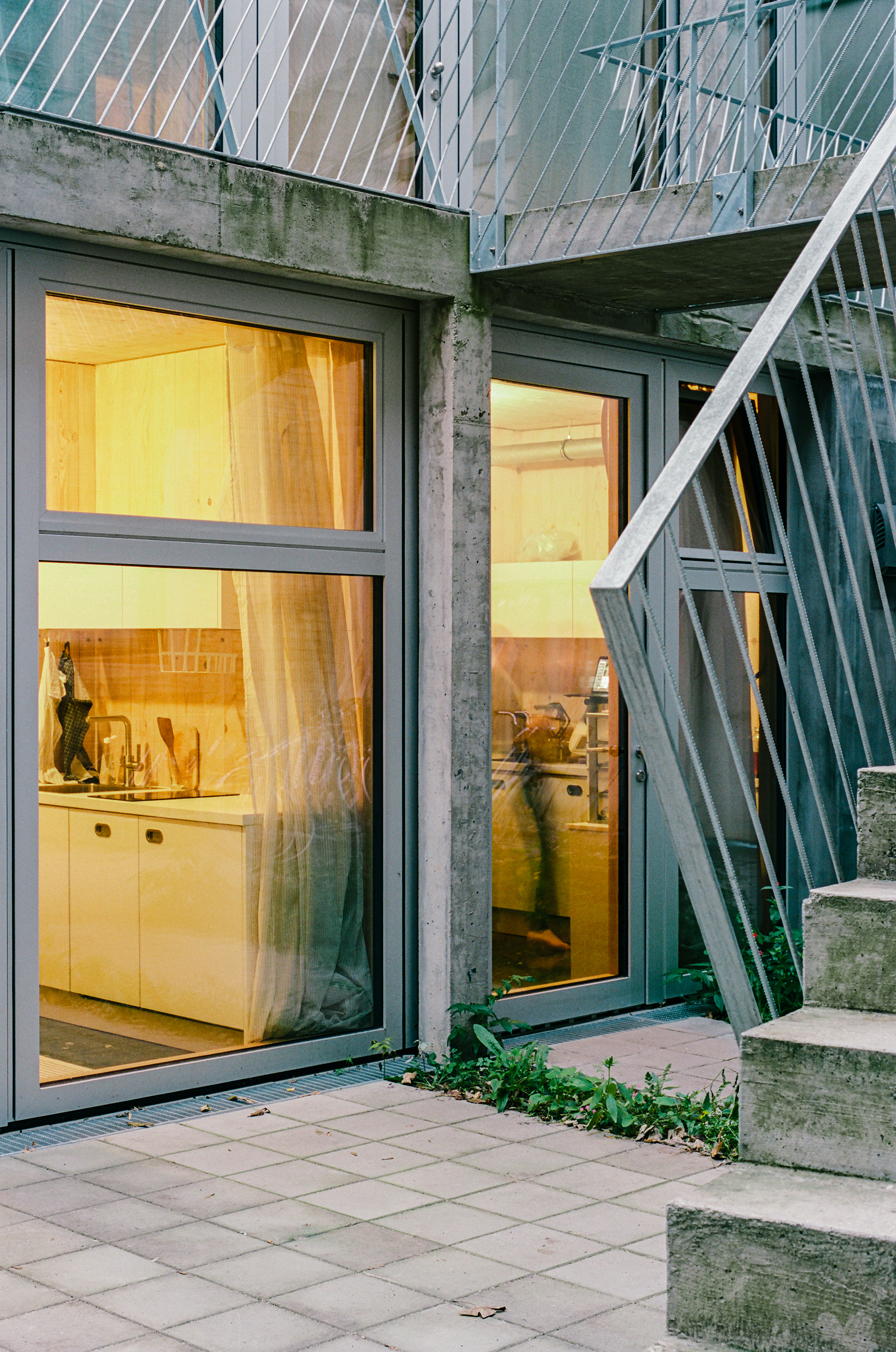 The exterior is raw and fits into the existing dense urban fabric.