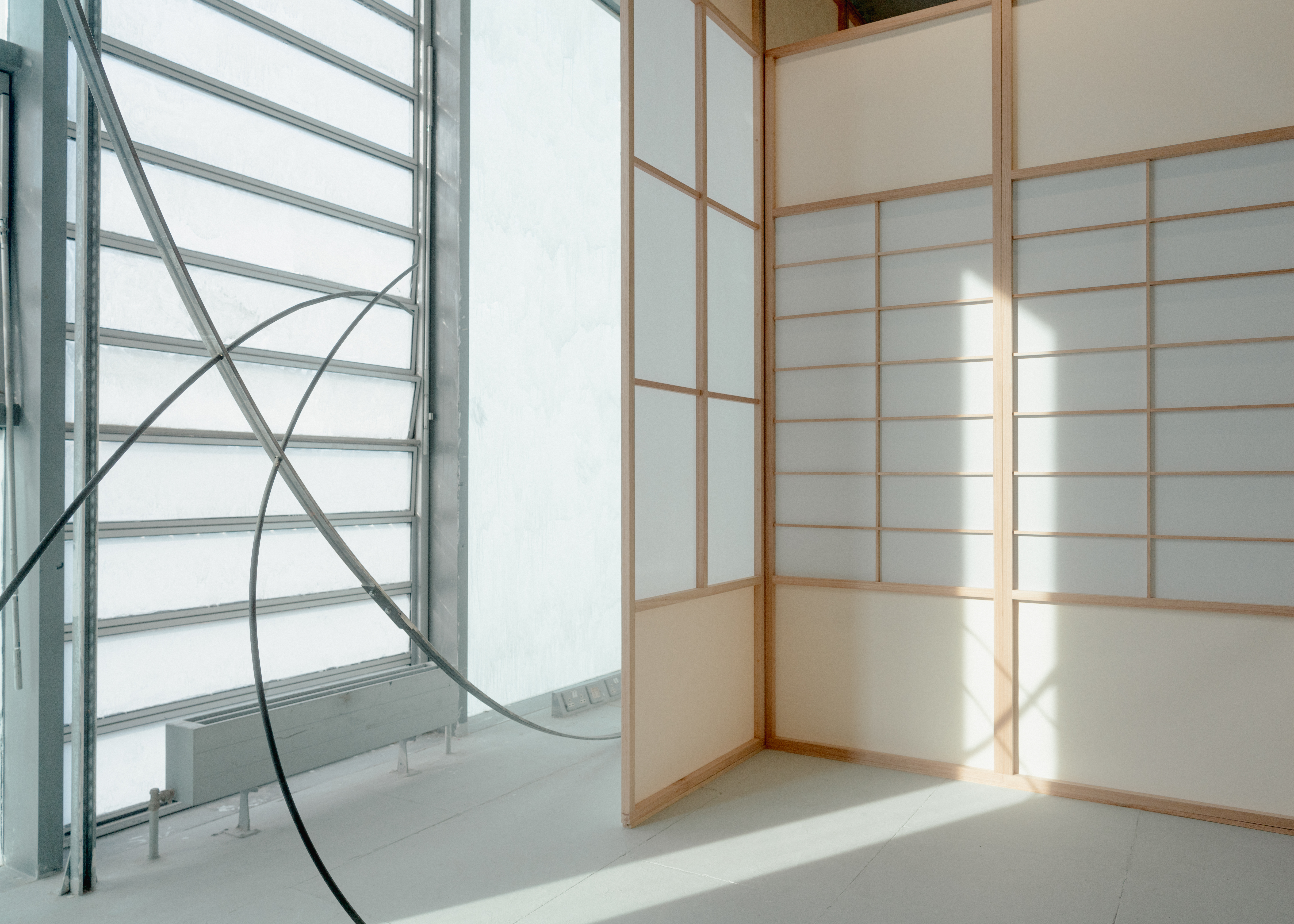 Installation featuring Bloom II, 2025. Steel, hardware, and Shōji, 2025. Red grandis, shōji paper, rice glue, drawing paper, tape.