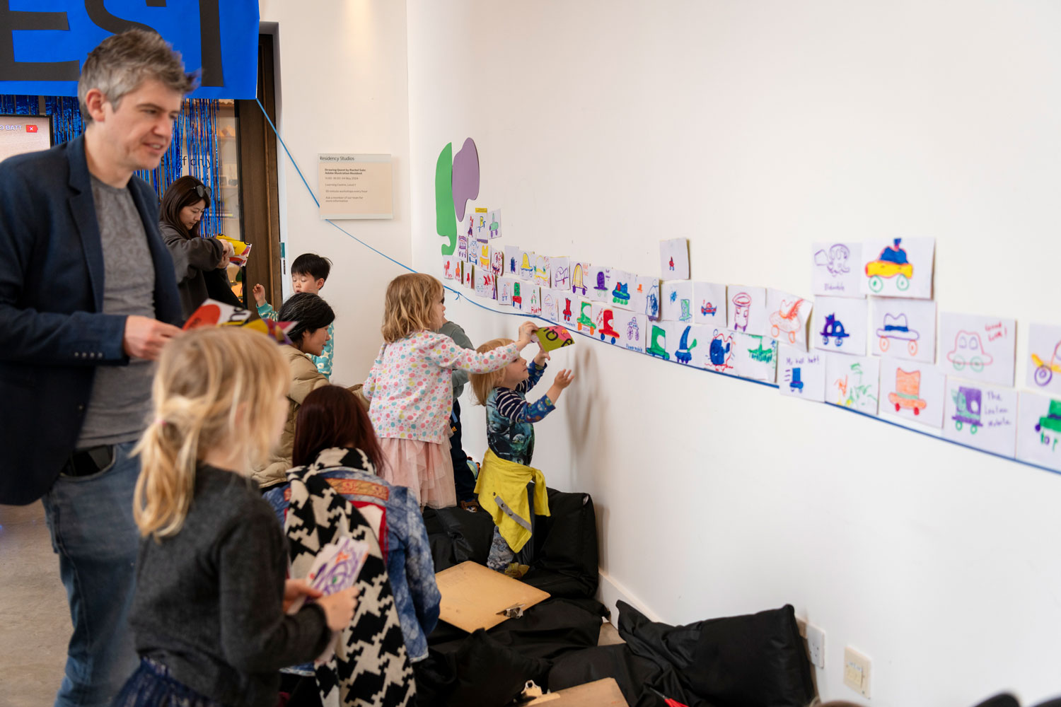 Adding our individual drawings to the wall and see the story in a new light. Photo by Sandra Ebert.