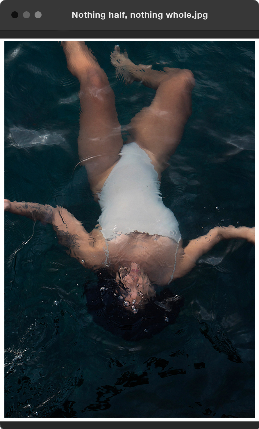 Nothing half, nothing whole: afro-european woman lying in the water and floating beneath the surface  