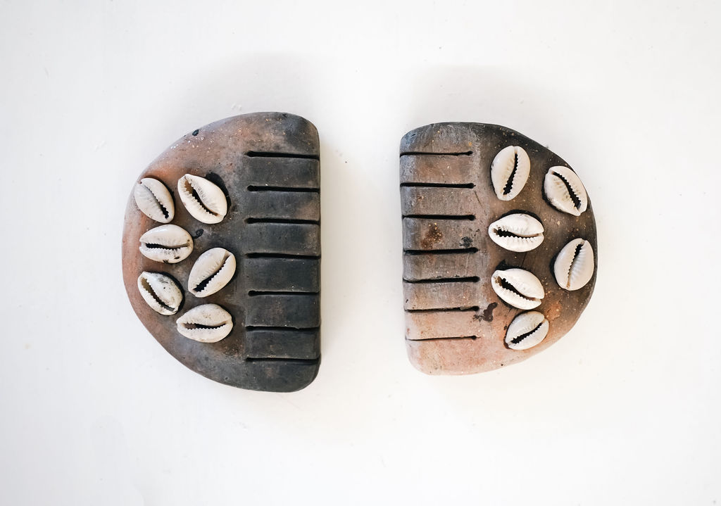 Koyozintli, The mediator (2 pieces), 2024. Clay, shells, mica, blessed object. 4"X4"