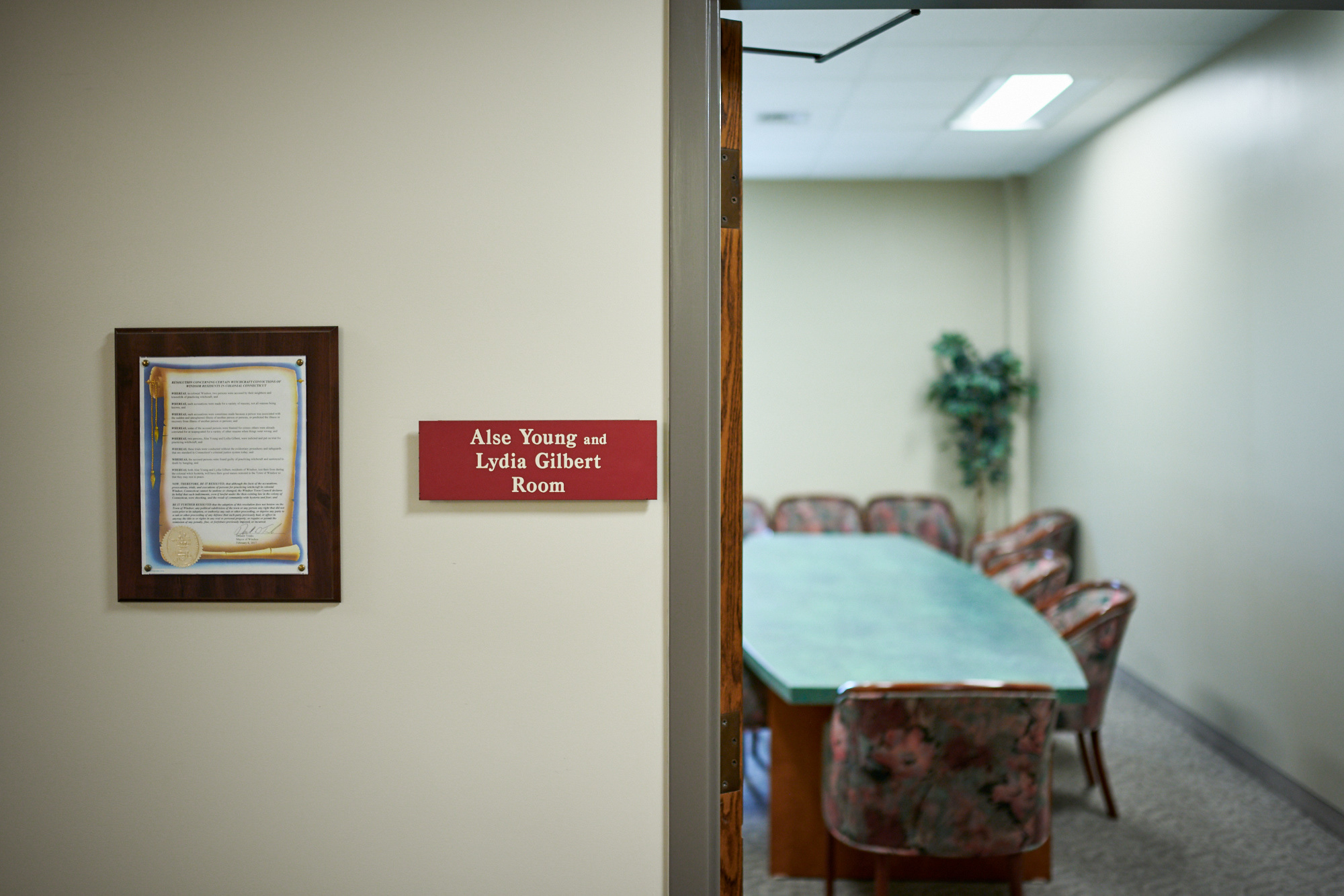 A placard designates a meeting room in the Windsor City Hall building. This is one of several small overtures acknowledging the executions of Alse Young (1647) and Lydia Gilbert (1654), who were posthumously pardoned by Windsor’s Town Council in 2017—largely due to the efforts of local activists. Windsor, CT.