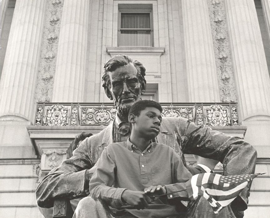 David Johnson: Boy and Lincoln, 1963; [outside City Hall in San Francisco during NAACP-sponsored demonstration]; gelatin silver print; David Johnson photograph archive, BANC PIC 2017.001, The Bancroft Library, University of California, Berkeley.