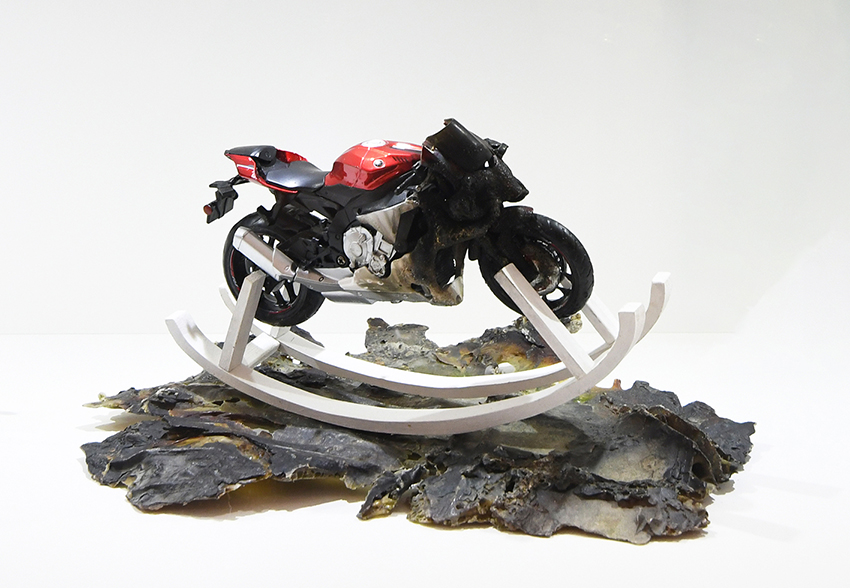Wild horse II, 27 x 19 x 22cm crash motorbike (toy) on wood, melt plastic found in the sea