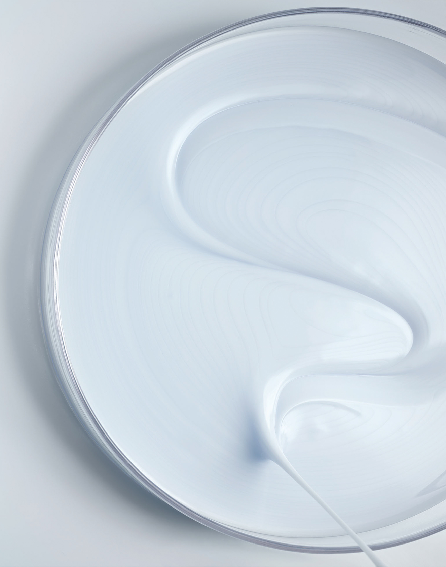 KMA photographer Daniel Schweizer shoots a texture and beauty photo of a creamy white substance in a bottle