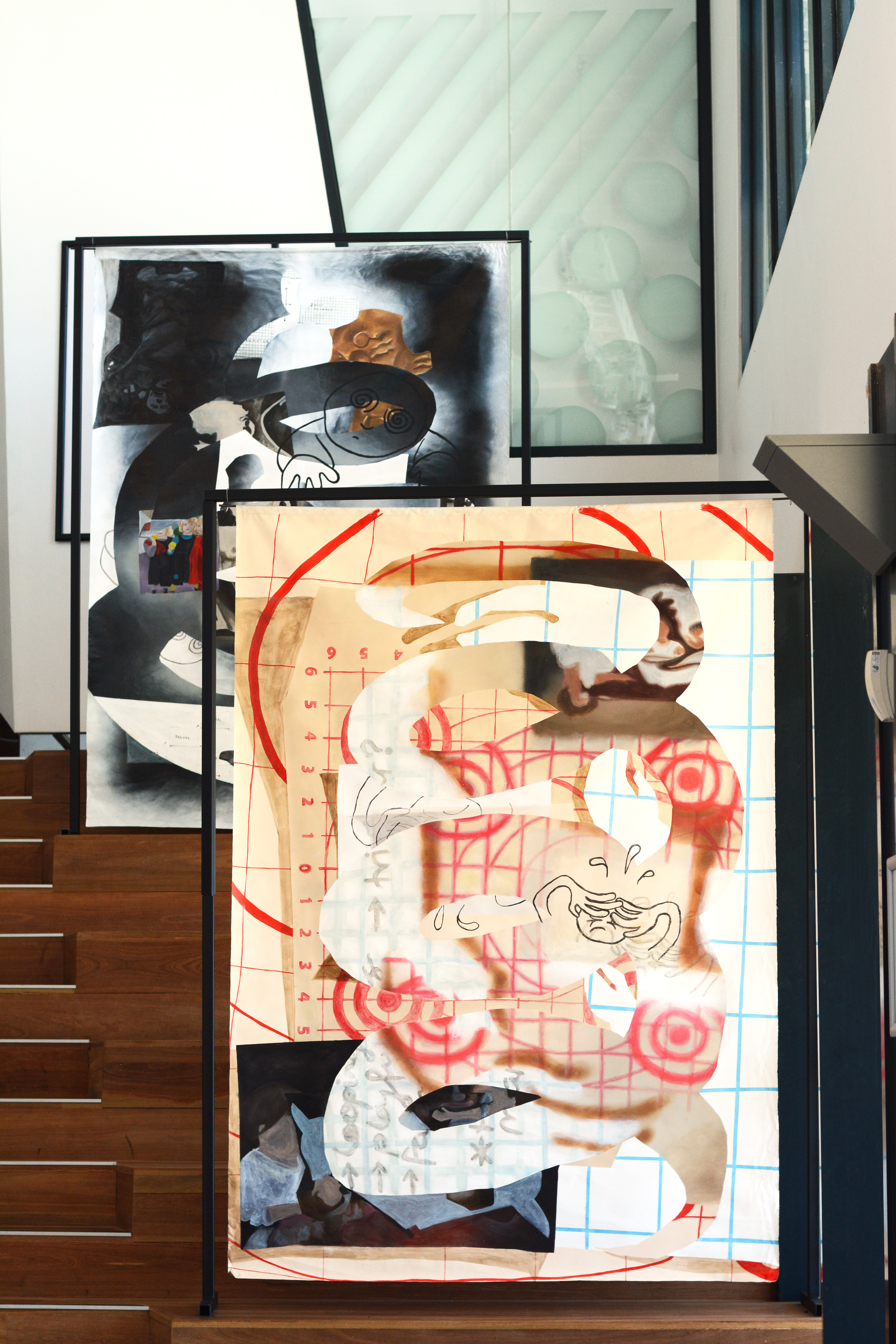 Shadow Puppets: Installation View of Target Practice and Entropy, Emma Lyn Winkler, 2022-2023, oil and acrylic paint on primed, un-stretched canvas suspended from steel frames, 2 x 1.5 meters.