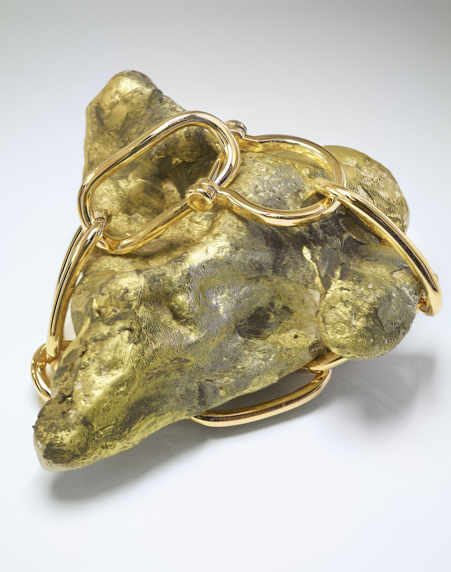 KMA photographer Daniel Schweizer photographs an abstract shot of a yellow rock wrapped in a gold chain