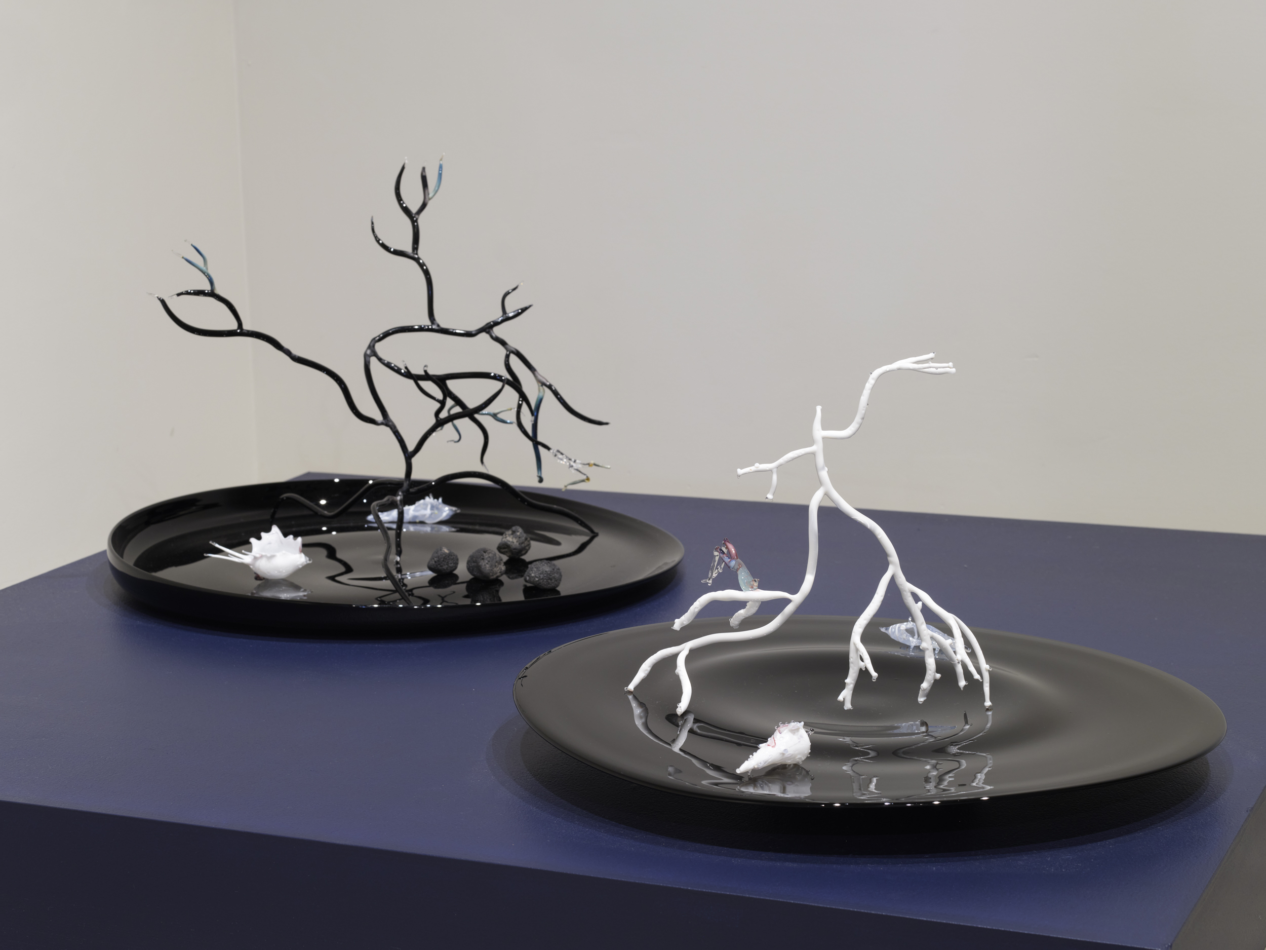 (Left) Goldie Poblador, Porites Oil Slick Coral, 2025. Glass, scent. 20 x 20 x 17.5 inches. Goldie Poblador, Porites Bleached Coral, 2025. Glass, scent, 17 x 20 x 19.5 inches. Scent by M Dougherty. Photo by Flaneurshan.studio