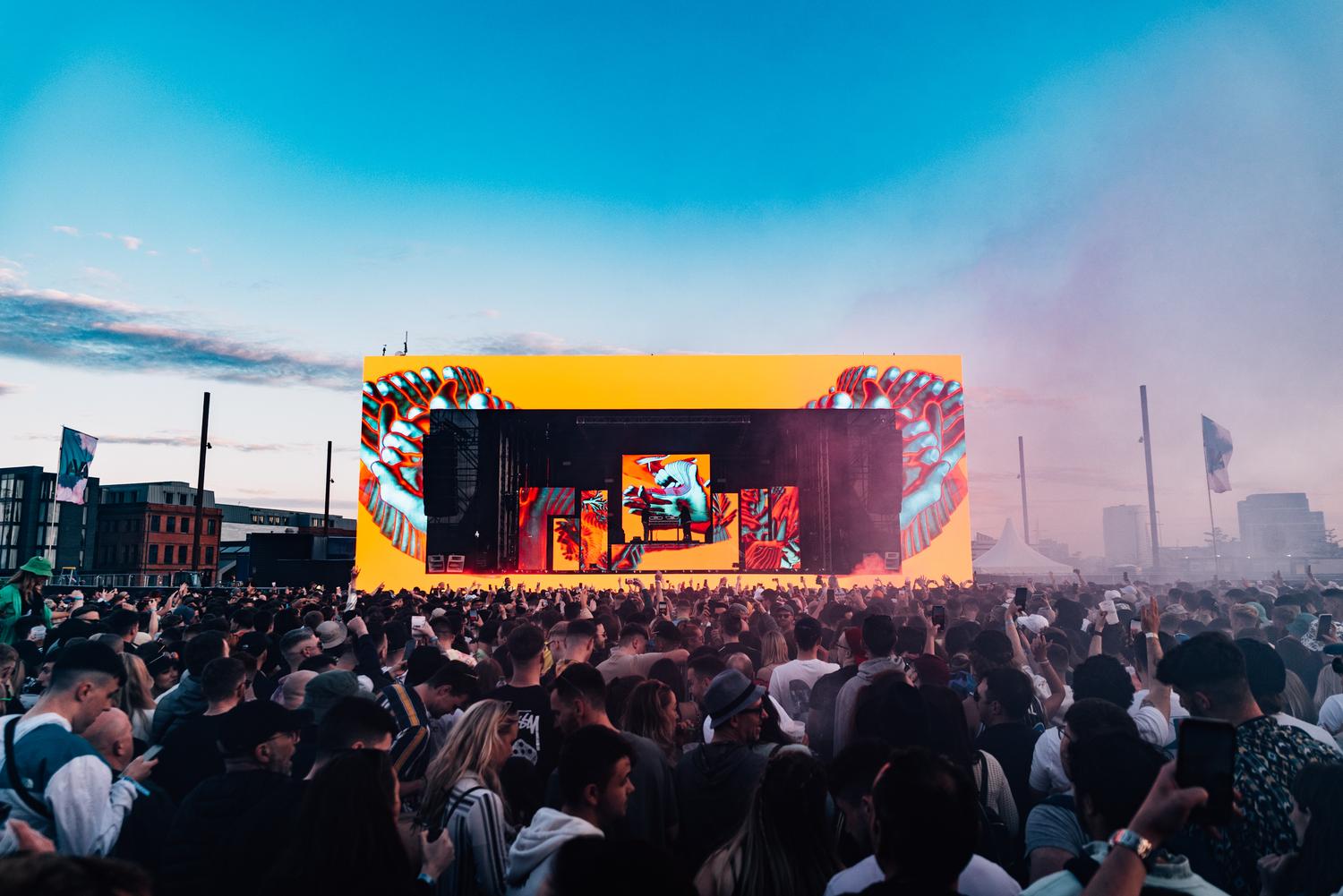 Bicep live show at AVA Festival Belfast with dramatic golden stage lighting and silhouette performance