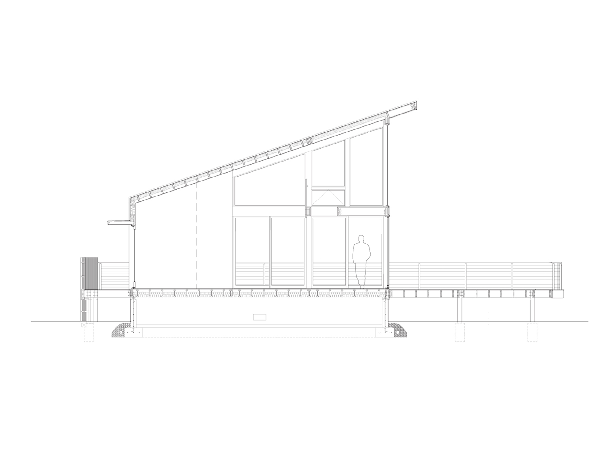 Architectural section drawing of the River Retreat cabin, illustrating the single-pitch sloped roof, the double-height living area, and the elevated structure extending onto the expansive exterior deck.