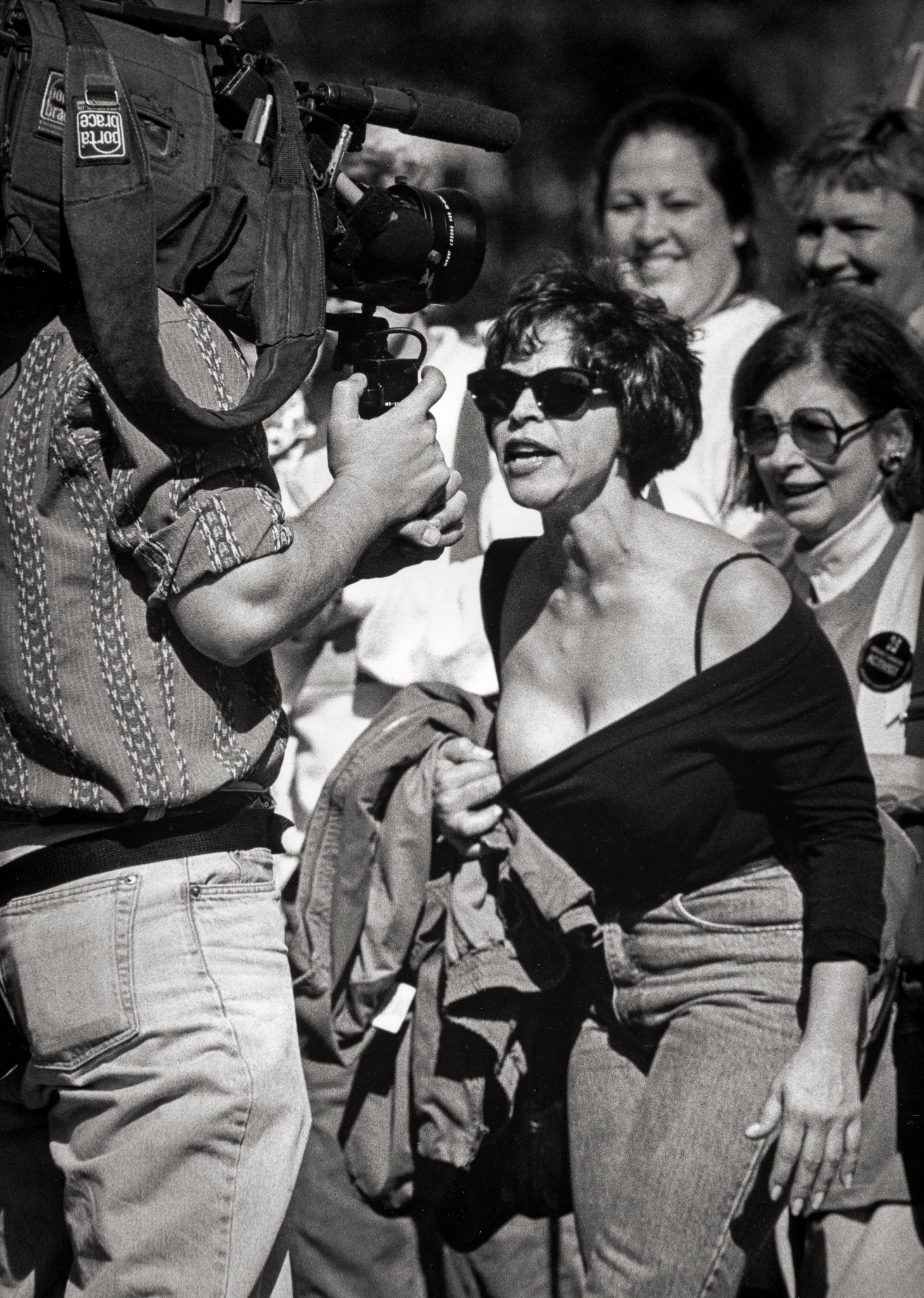 Diane seeks solidarity at a breast cancer march in Washington DC. Women in pink shirts are laughing, smiling, feeling the camaraderie of survivors with a shared history and purpose.She feels no connection with them. She expected tears, shouting, but sees none of the anger she feels. In frustration, she yanks her shirt down, revealing her partially reconstructed chest to a cameraman. "We don't want to see that," he says. "I know you don't want to see it," she screams, "that's why you have to see it."