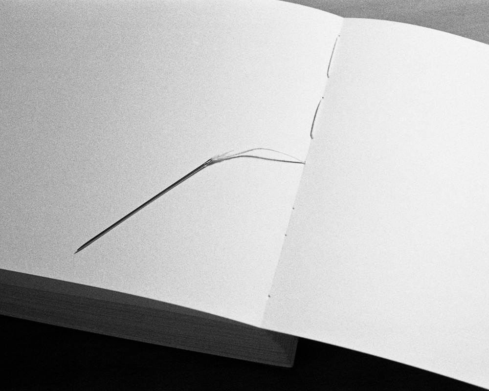 b. Sewing through each signature with beewaxed string