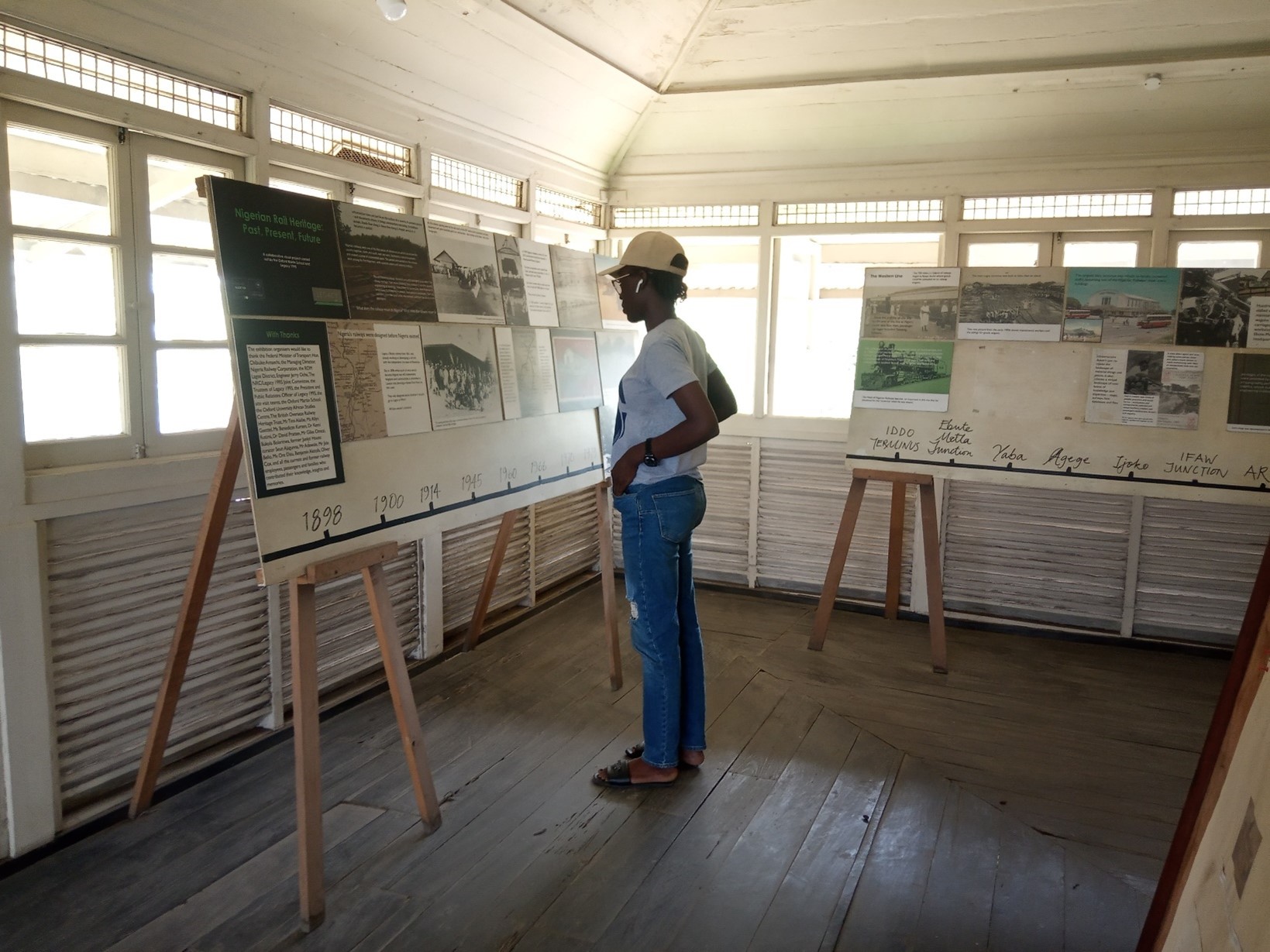 Grace viewing information from a past exhibition on the Nigerian Railway Heritage: Past, Present, Future which took place at Jaekel House.