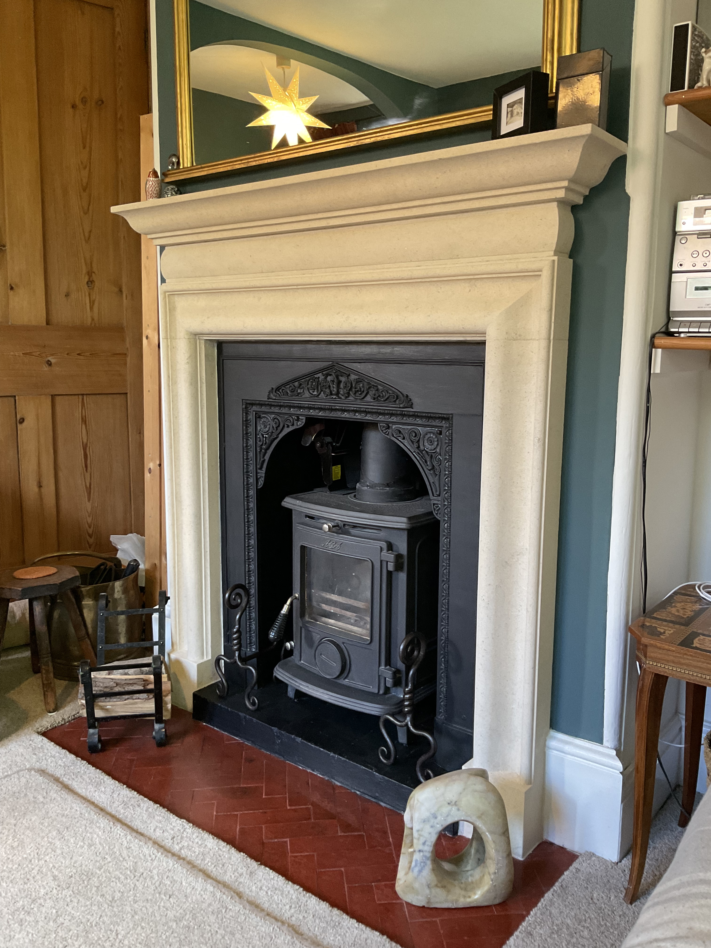 Bolection in Bath stone, with tile and brick hearth